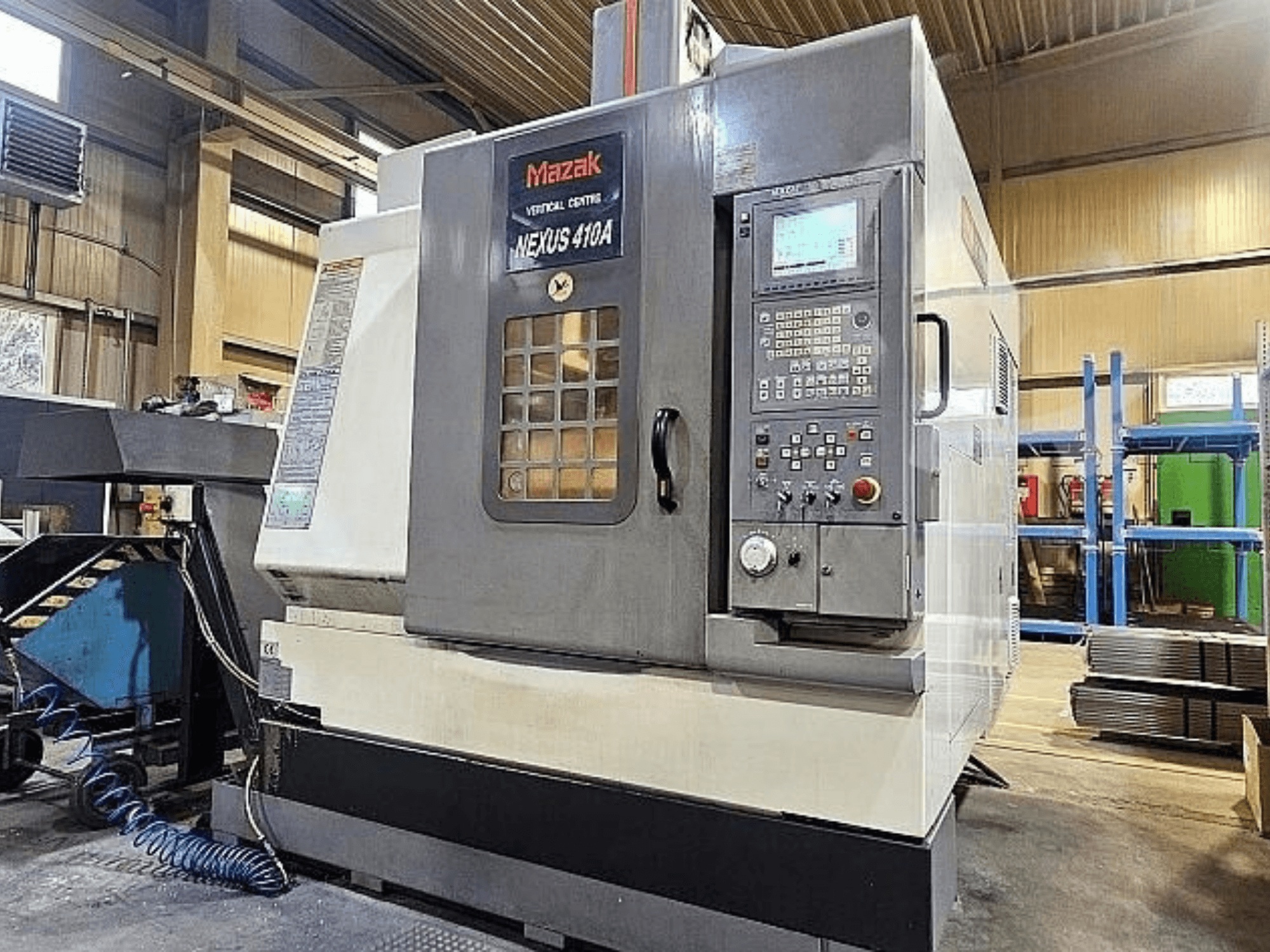 Mazak VCN-410A vertical machining center, side view showing control panel, tool holder, and operational features.