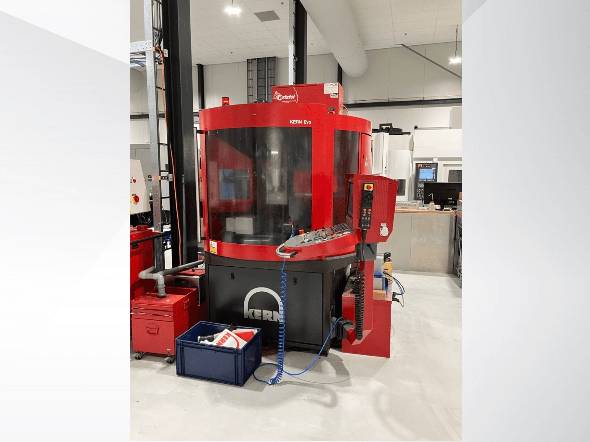 KERN Evo machining center in red and black, front view, showing control panel and surrounding equipment in a modern workshop.