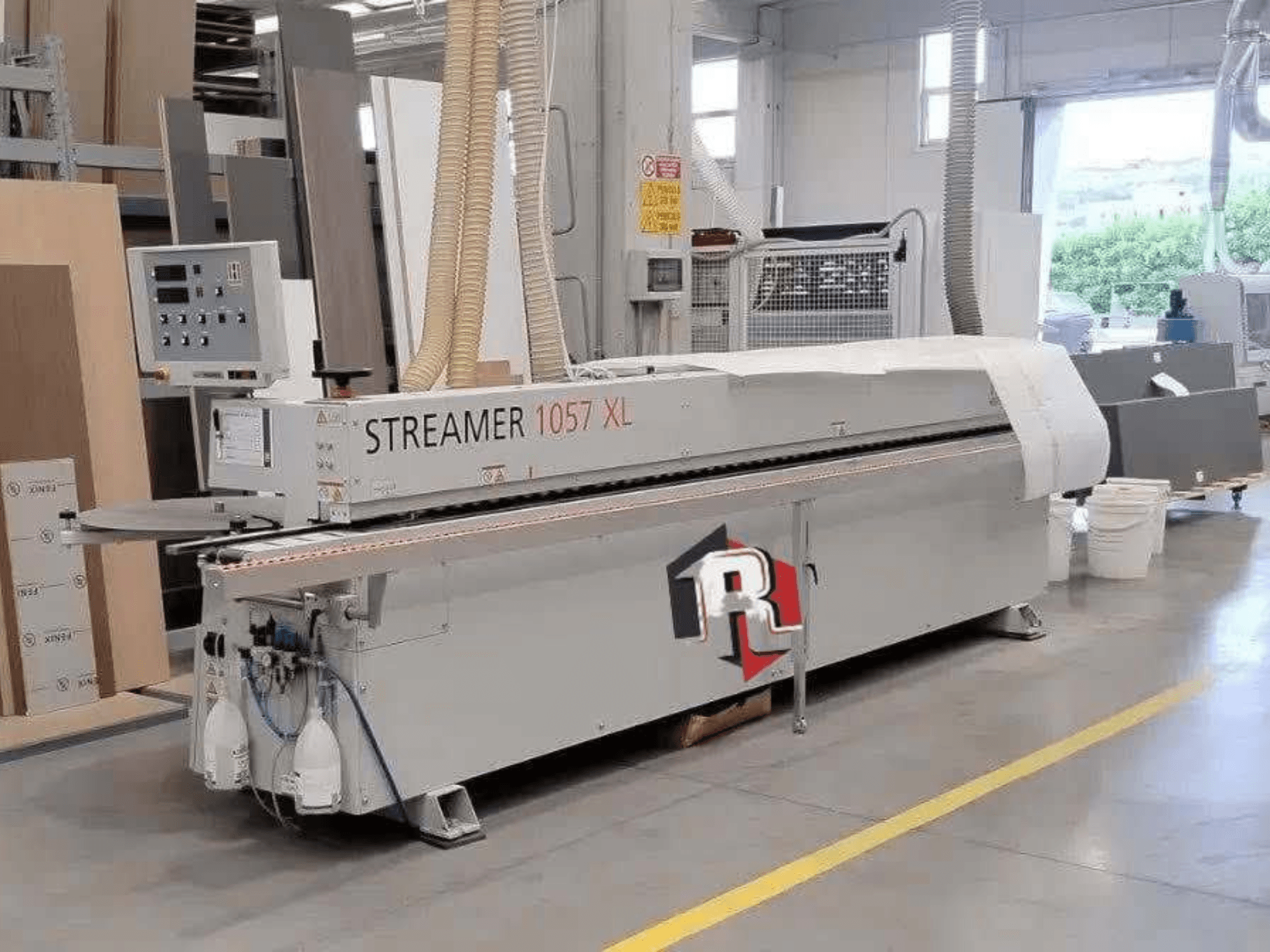 HOLZHER STREAMER 1057 XL edgebander in a workshop, side view with visible control panel and air hoses.