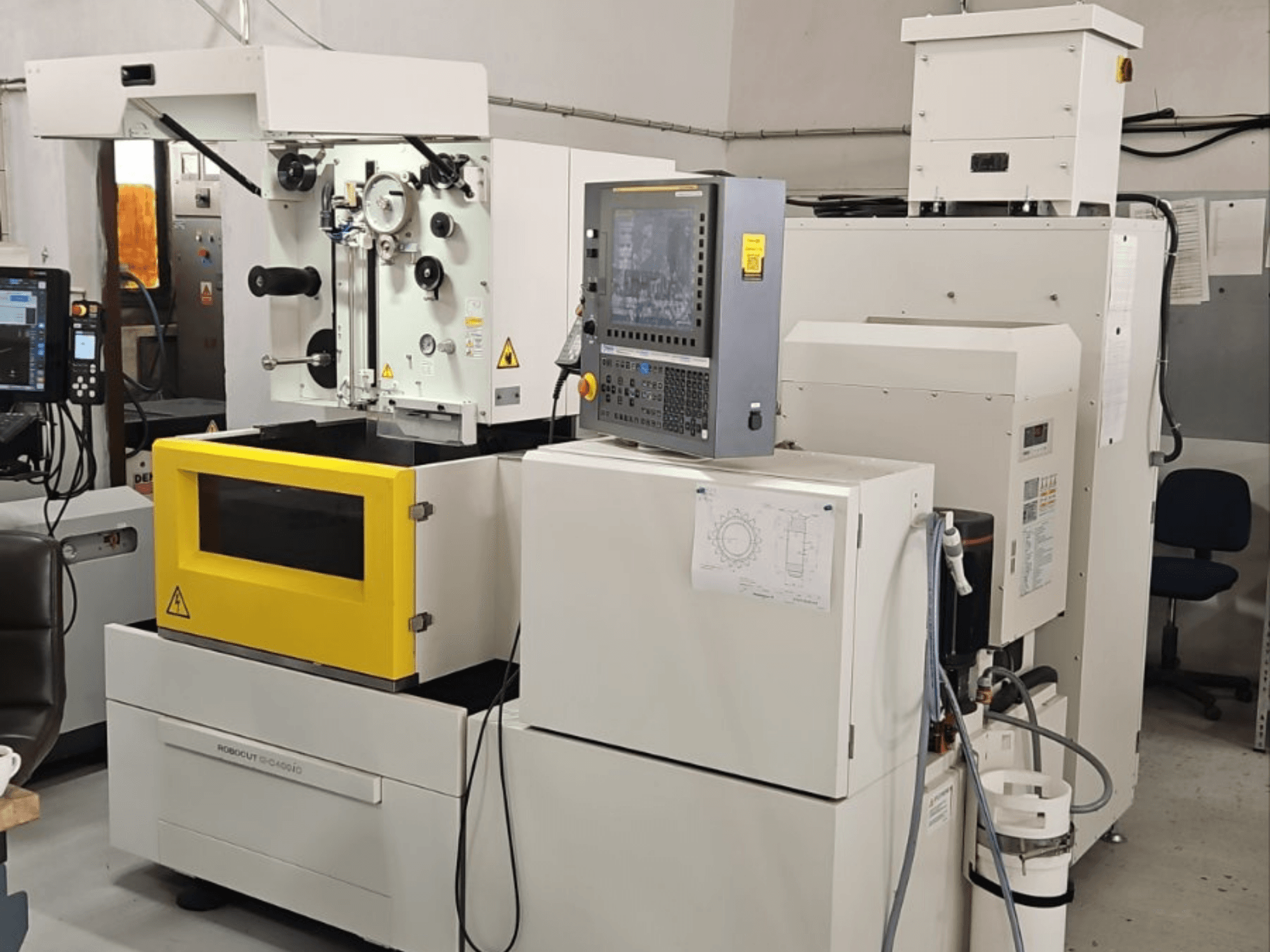 FANUC Robocut alpha C400iC Wire EDM machine, front view showcasing control panel and yellow work chamber.