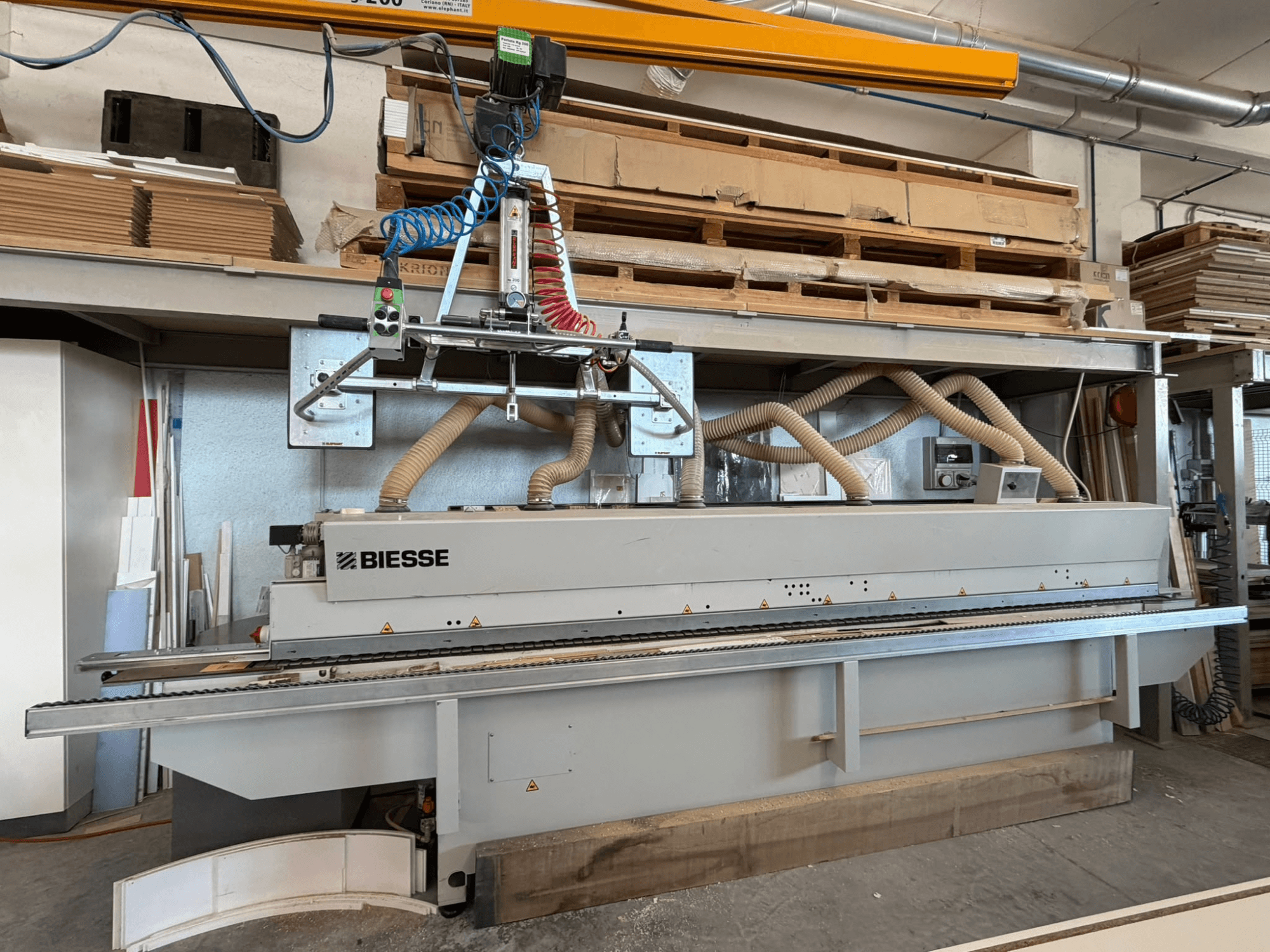 BIESSE AKRON 1330 edgebander in a workshop, showing front view with control panel and dust extraction system.