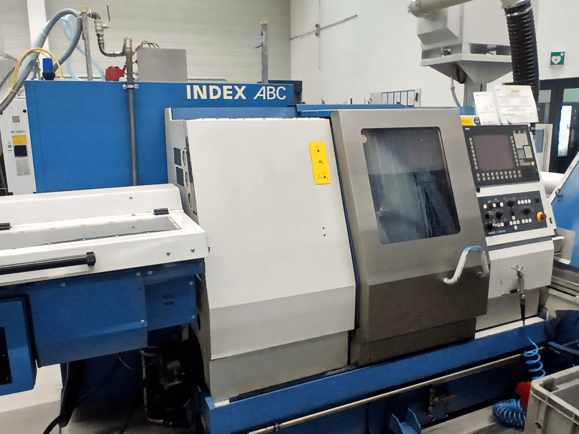 Horizontal turning machine Index ABC in blue and silver, front view showing control panel and work area.