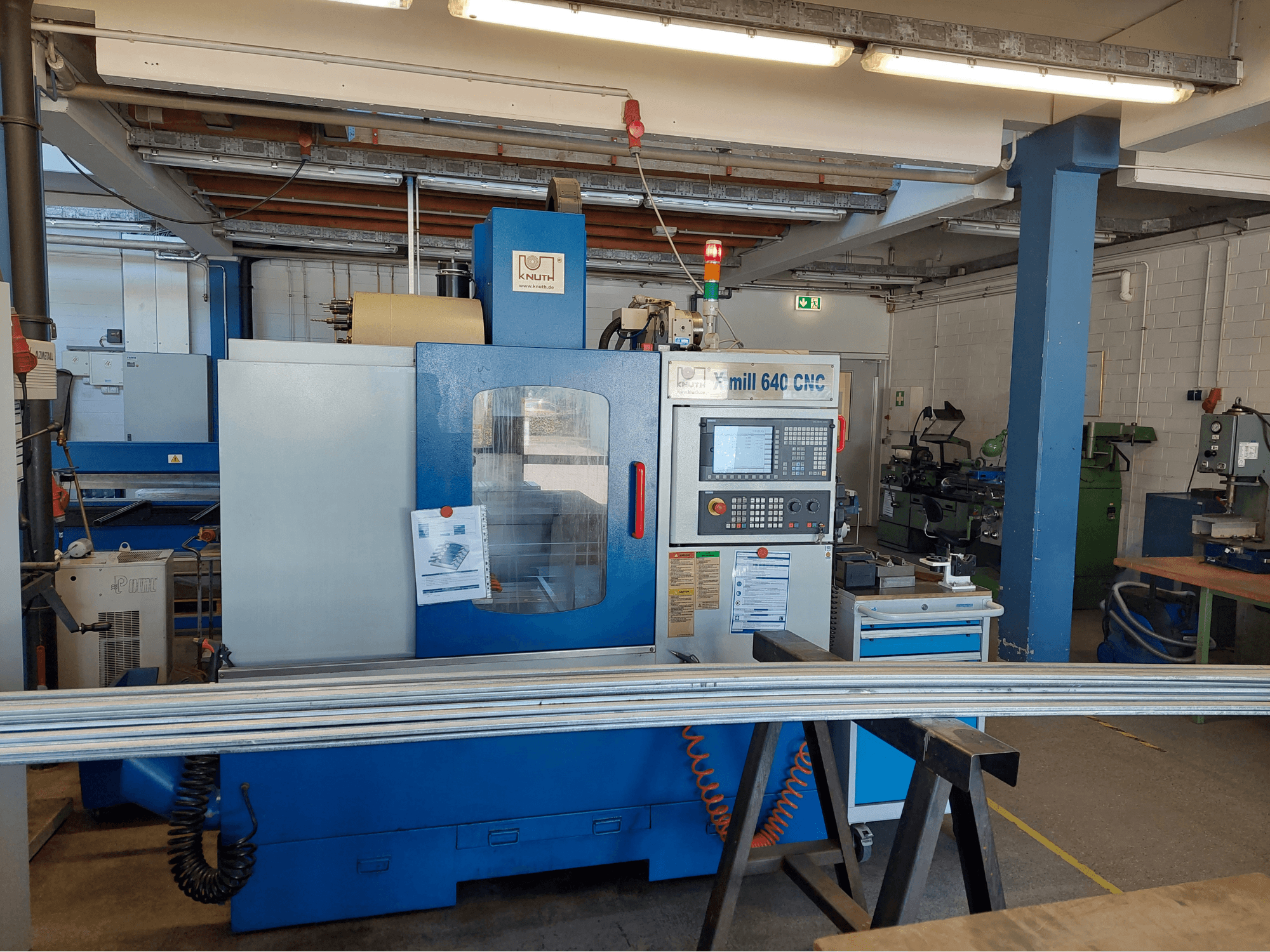 KNUTH X-Mill 640 vertical machining center, front view, featuring a control panel and work surface in a workshop setting.