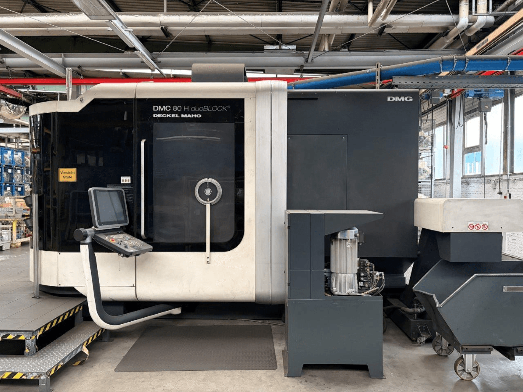 Horizontal view of DECKEL MAHO DMC 80 H duoBLOCK Machining Center, featuring control panel and machinery details.