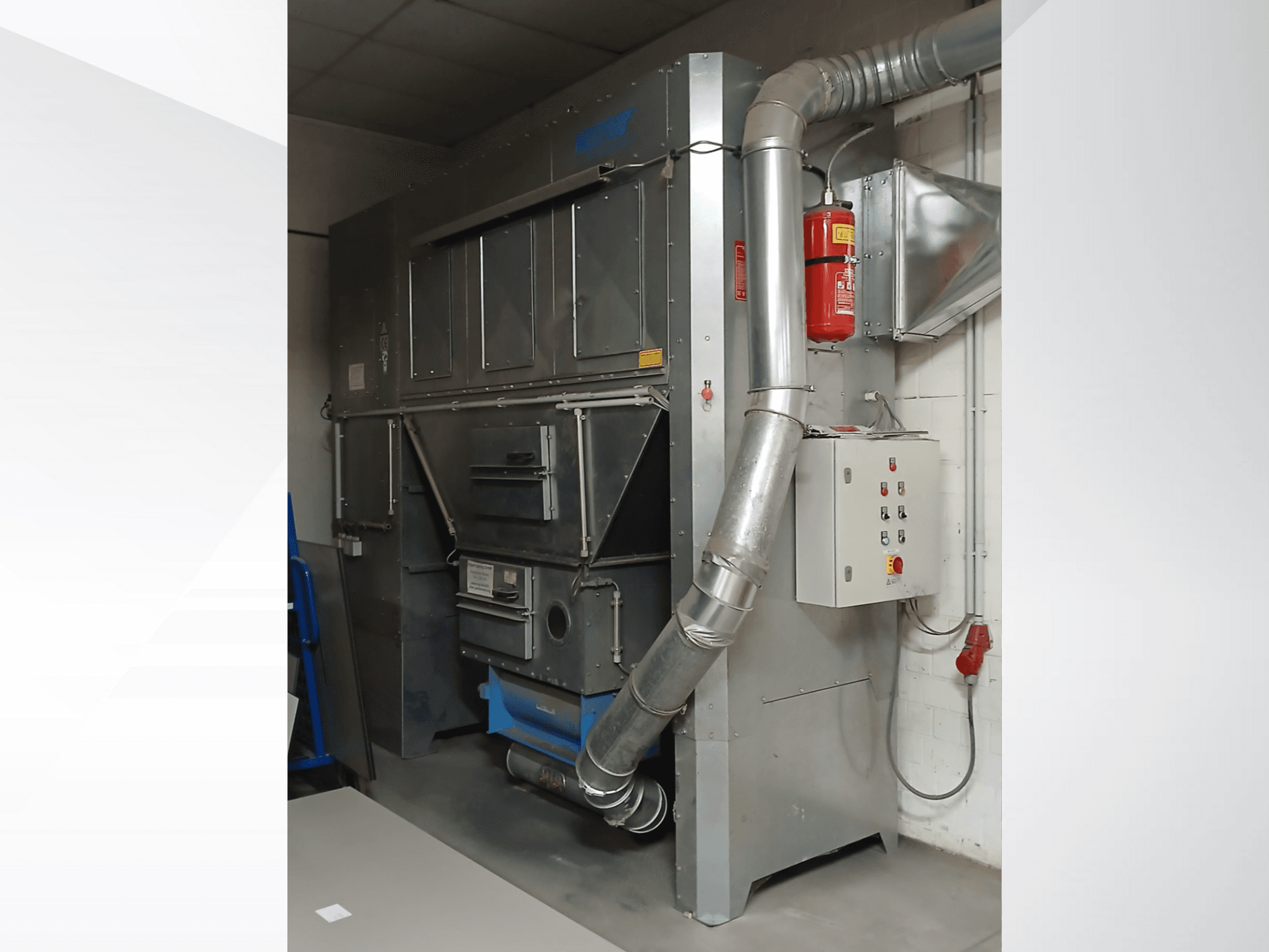 Industrial dust collector unit, gray metal, front view; features exhaust duct, control panel, and fire extinguisher.