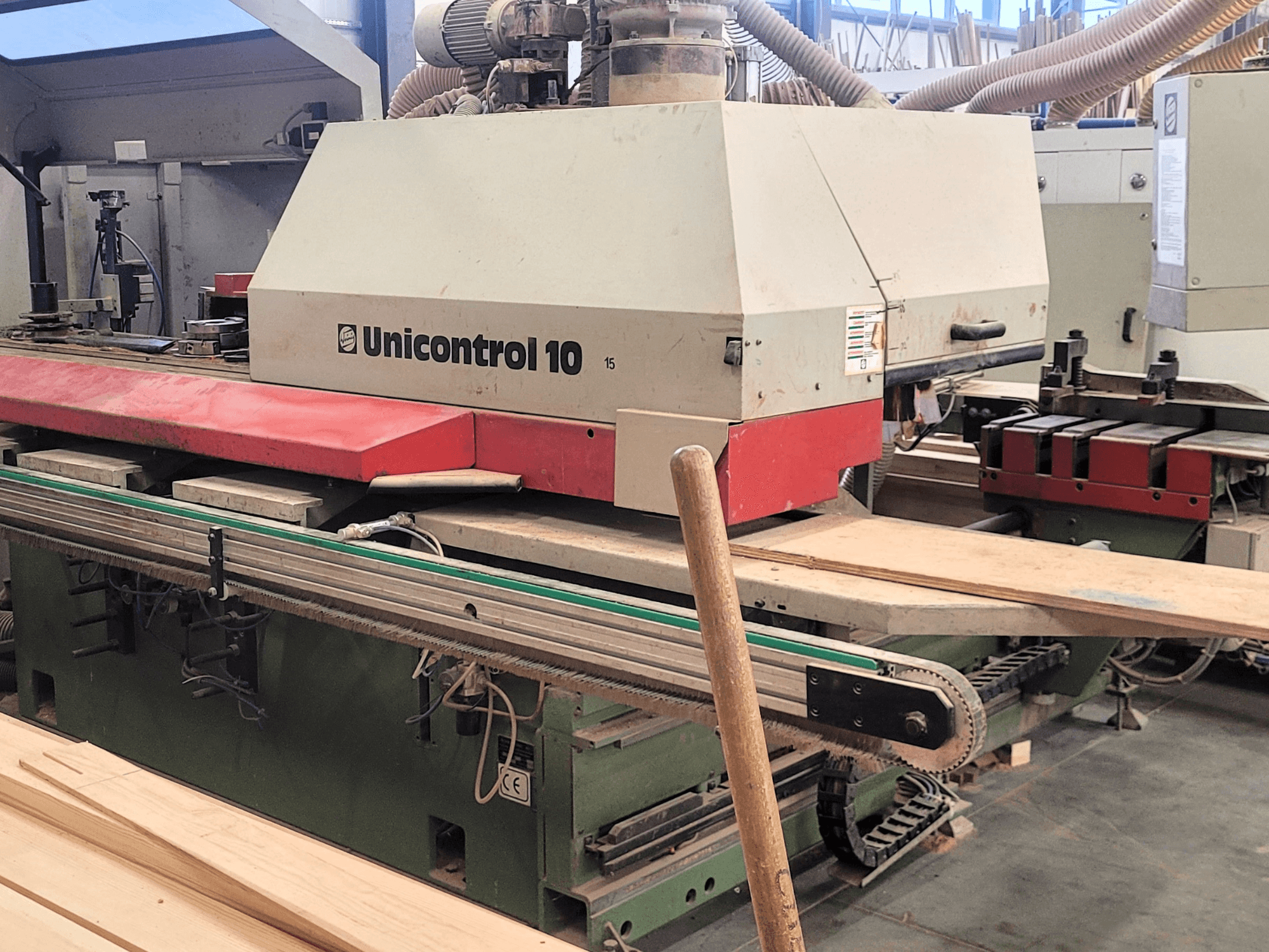 CNC Processing Center Unicontrol 10 by WEINIG/DIMTER, front view with wooden boards and equipment in a workshop setting.