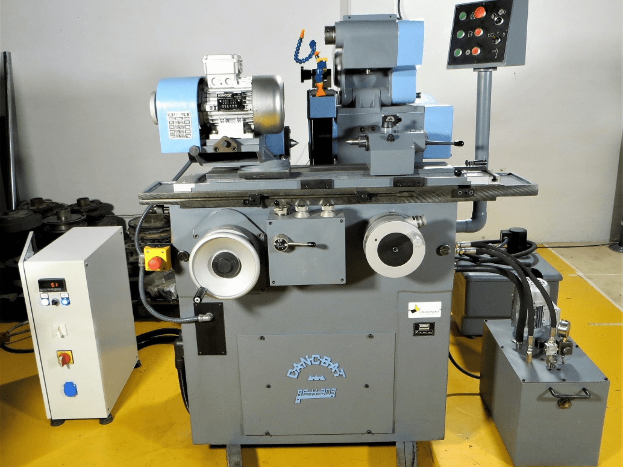 DANOBAT RE H 305 surface grinding machine in front view, featuring motor, controls, and grinding wheel for precision work.