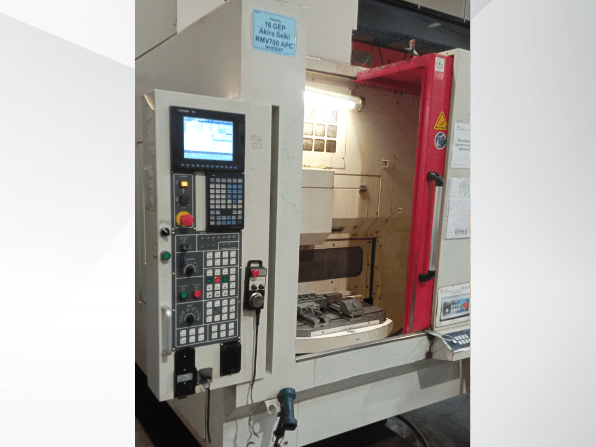 Akira Seiki RMV 700 APC vertical machining centre front view, featuring a digital control panel and work area with tools.