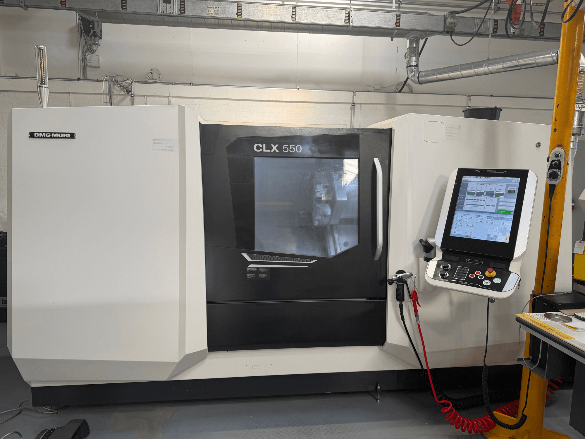DMG MORI CLX 550 V4 horizontal turning machine, front view with control panel and display, showcasing advanced machining features.