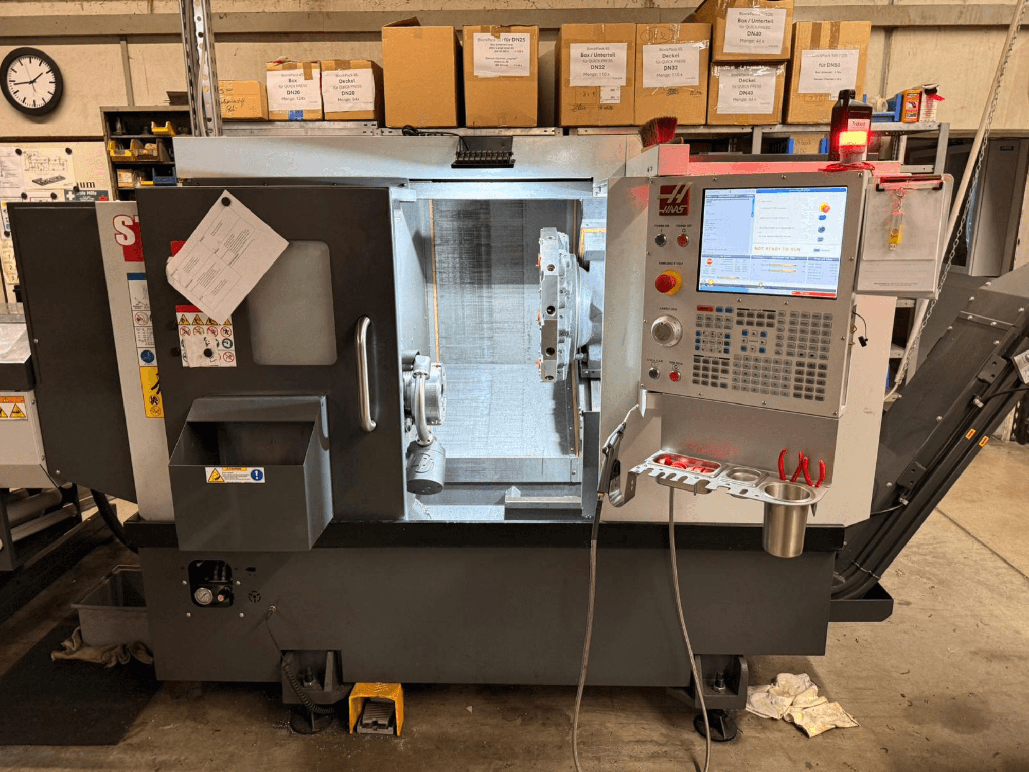HAAS ST-15 horizontal turning machine shown from a side view, featuring a digital control panel and operational components.