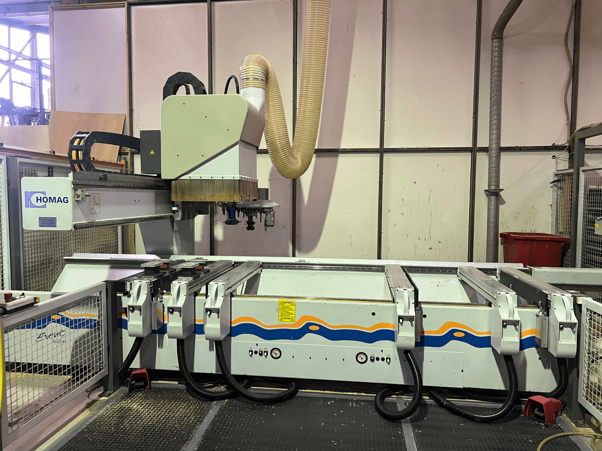 HOMAG BIZ 4 CNC machine in workshop; front view showing dust extraction system and control panel with cables.