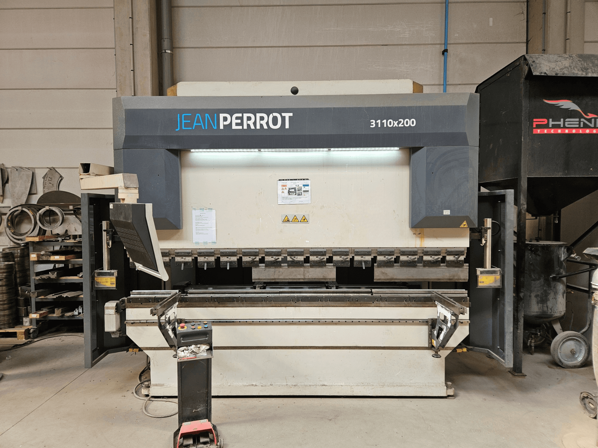 Hydraulic Press Baykal APHS 31200 shown in front view, featuring a large work table and control panel, set in a workshop.