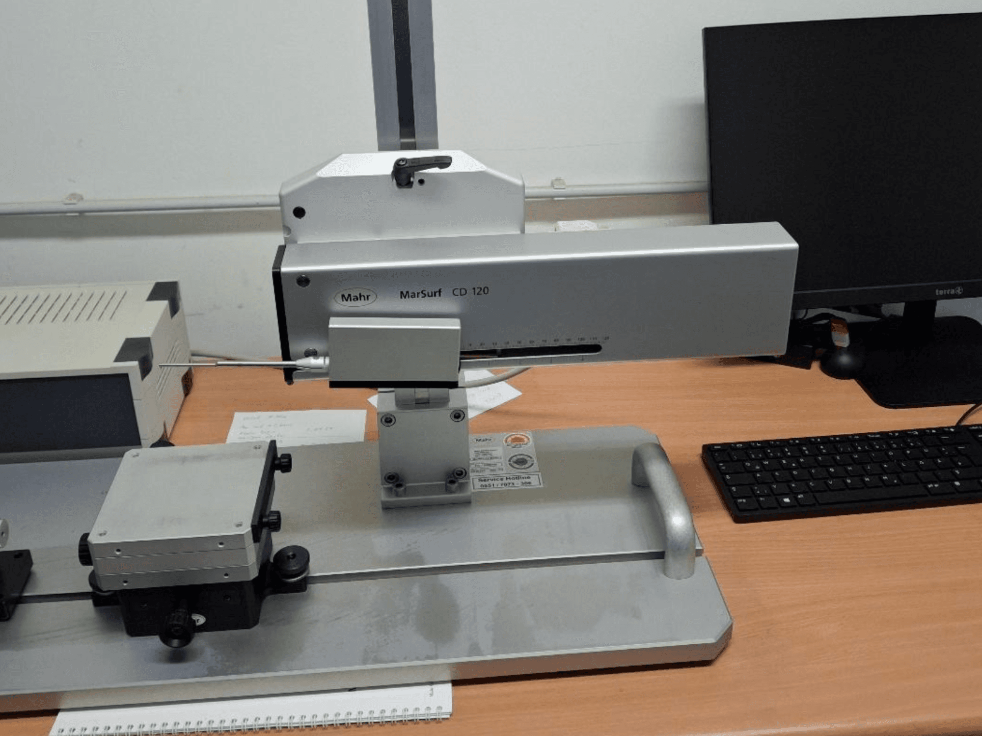Mahr MARSURF CD 120 CMM viewed from the front, showcasing measurement head, control panel, and mounted measuring table.