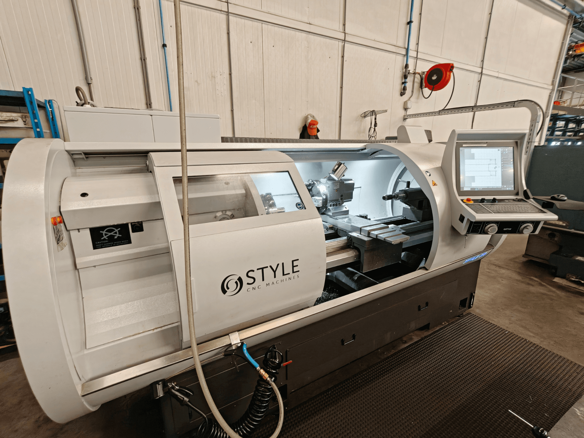 STYLE 510 horizontal turning machine, front view, features control panel and cutting tools visible inside the workspace.