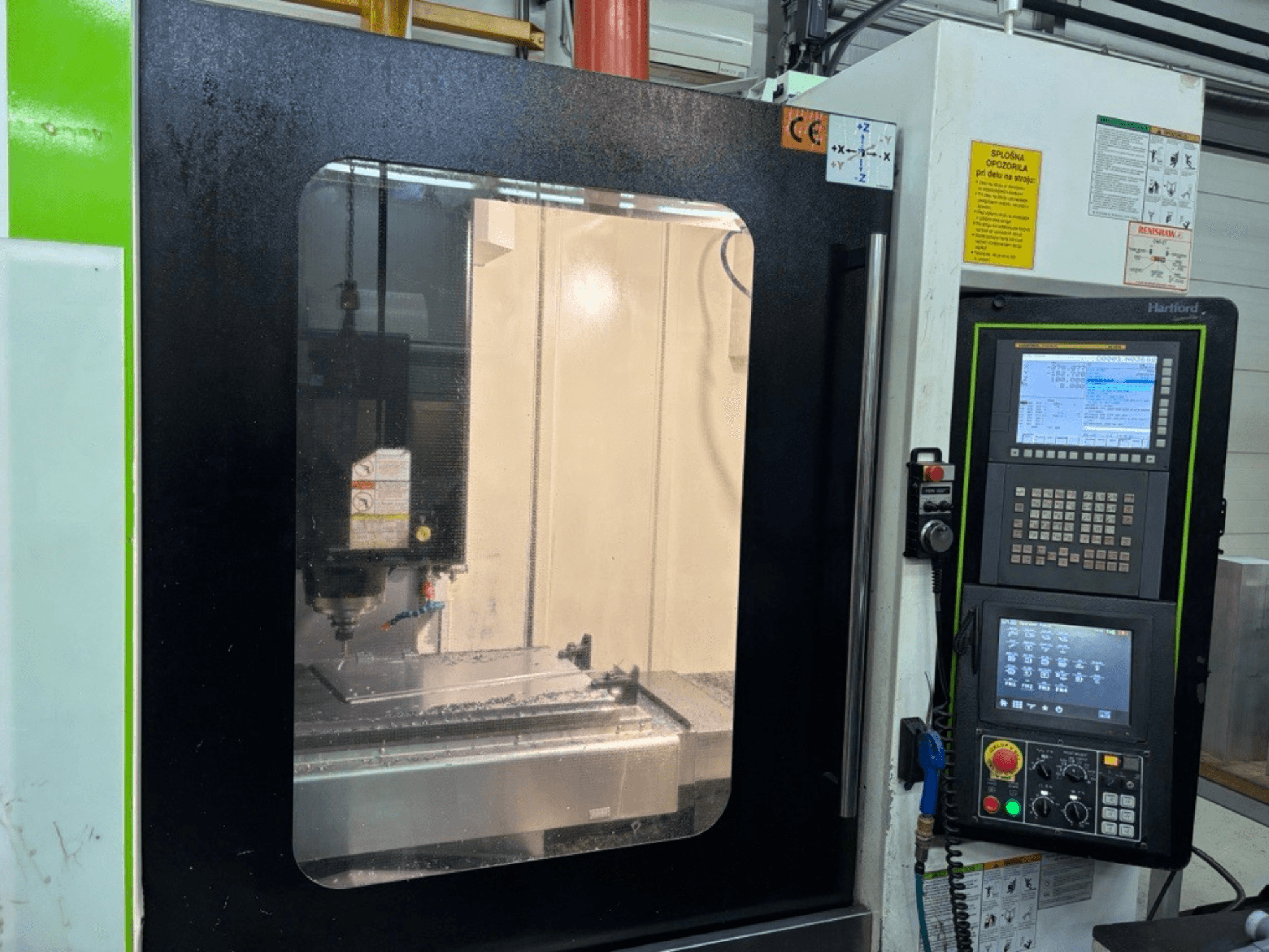 HARTFORD MVP-11 Vertical Machining Centre shown in front view, featuring control panel and machine workspace with coolant residue.