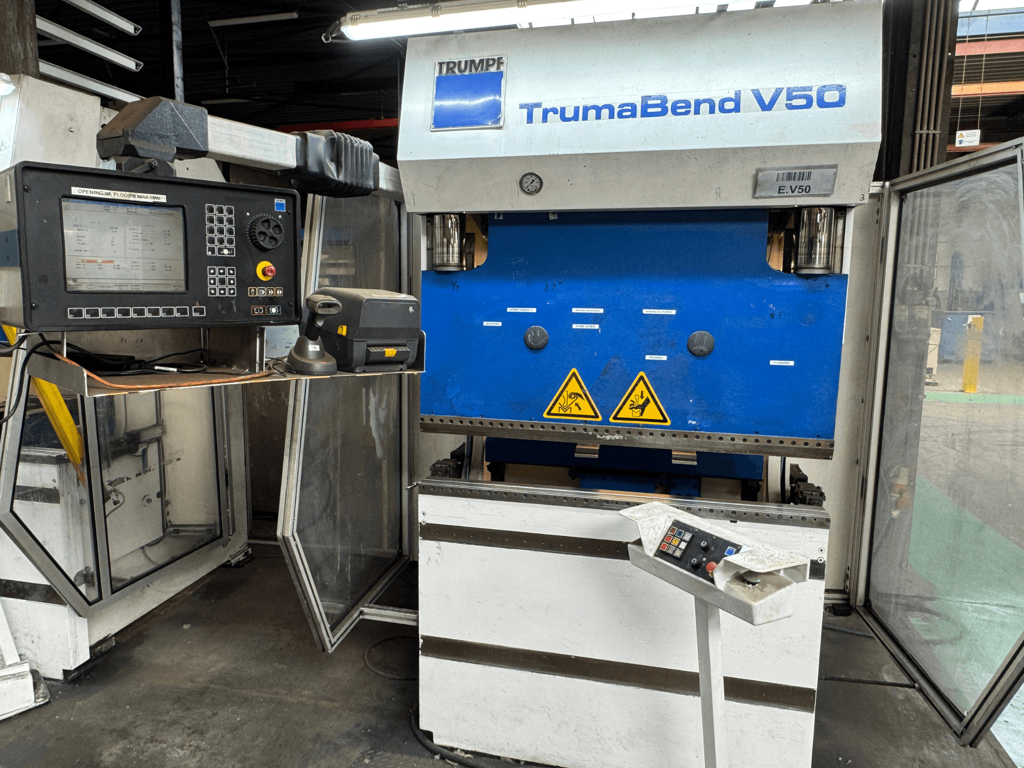 TRUMPF TrumaBend V50 press brake from a front view, featuring a control panel, safety warnings, and distinct blue and white design.
