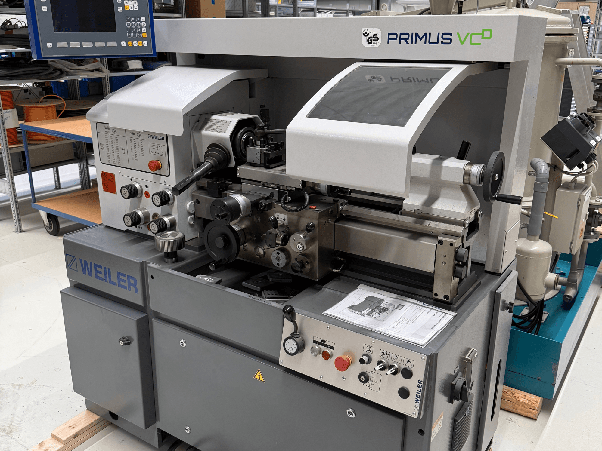 Weiler PRIMUS VCD horizontal turning machine, front view showing controls, spindle, and operational features in a workshop setting.