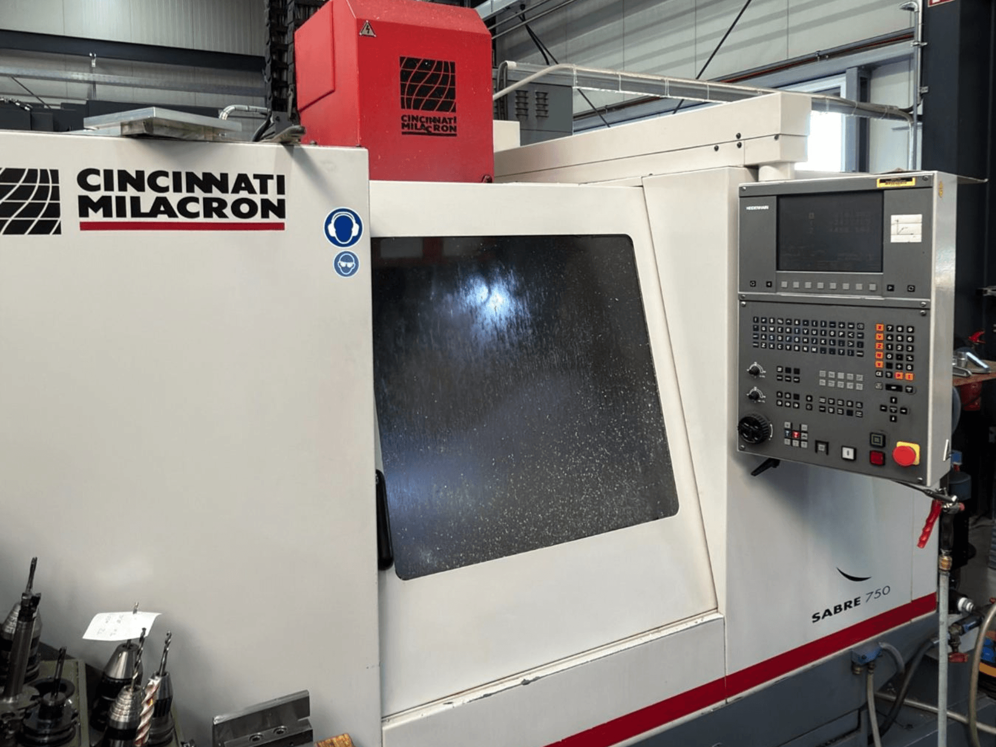 Cincinnati Milacron Sabre 750 vertical machining center, front view, with control panel and partially obscured glass.