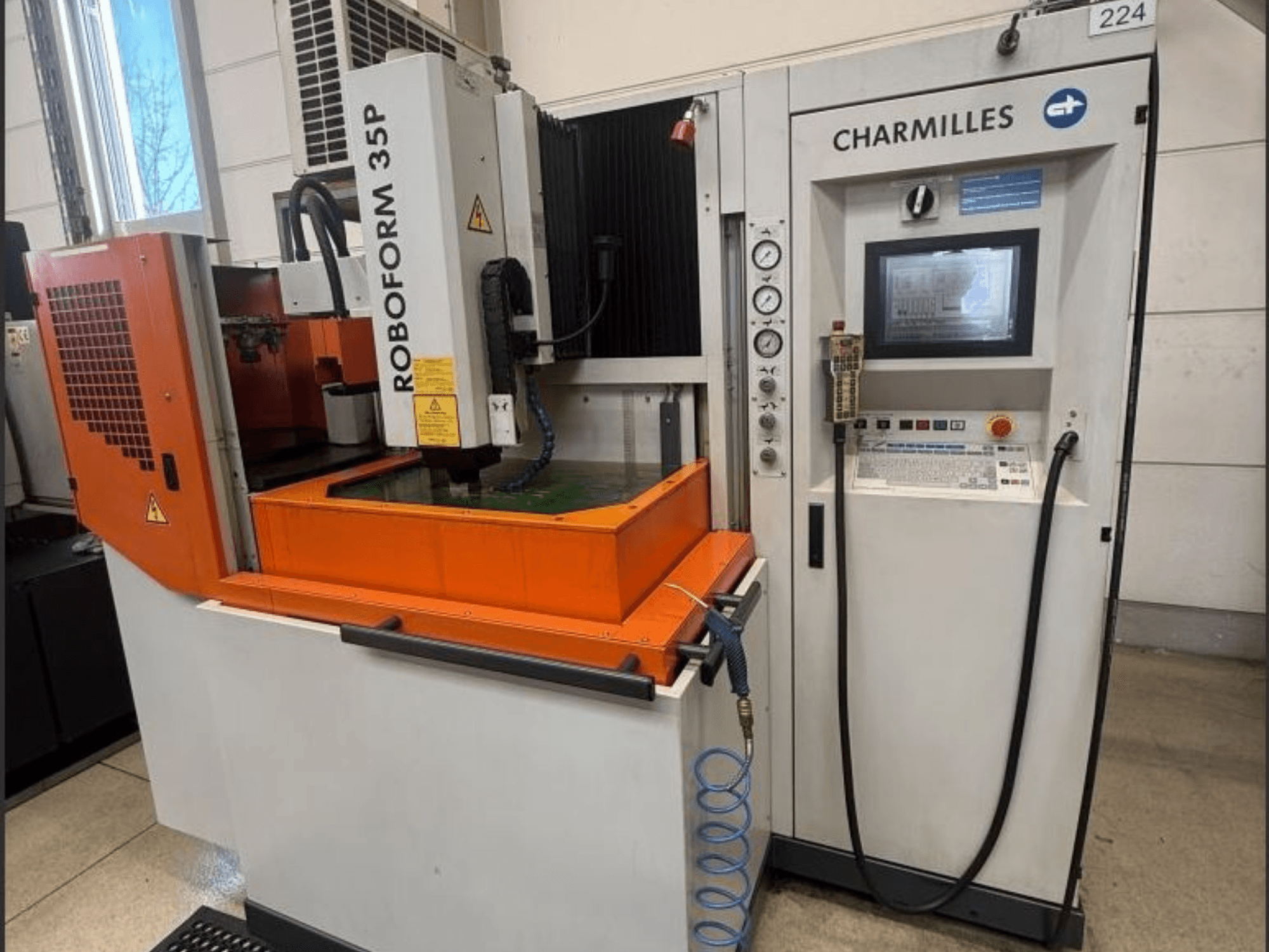Charmilles ROBOFORM 35P die-sinking EDM machine, front view, featuring control panel, gantry, and fluid tank in operation.
