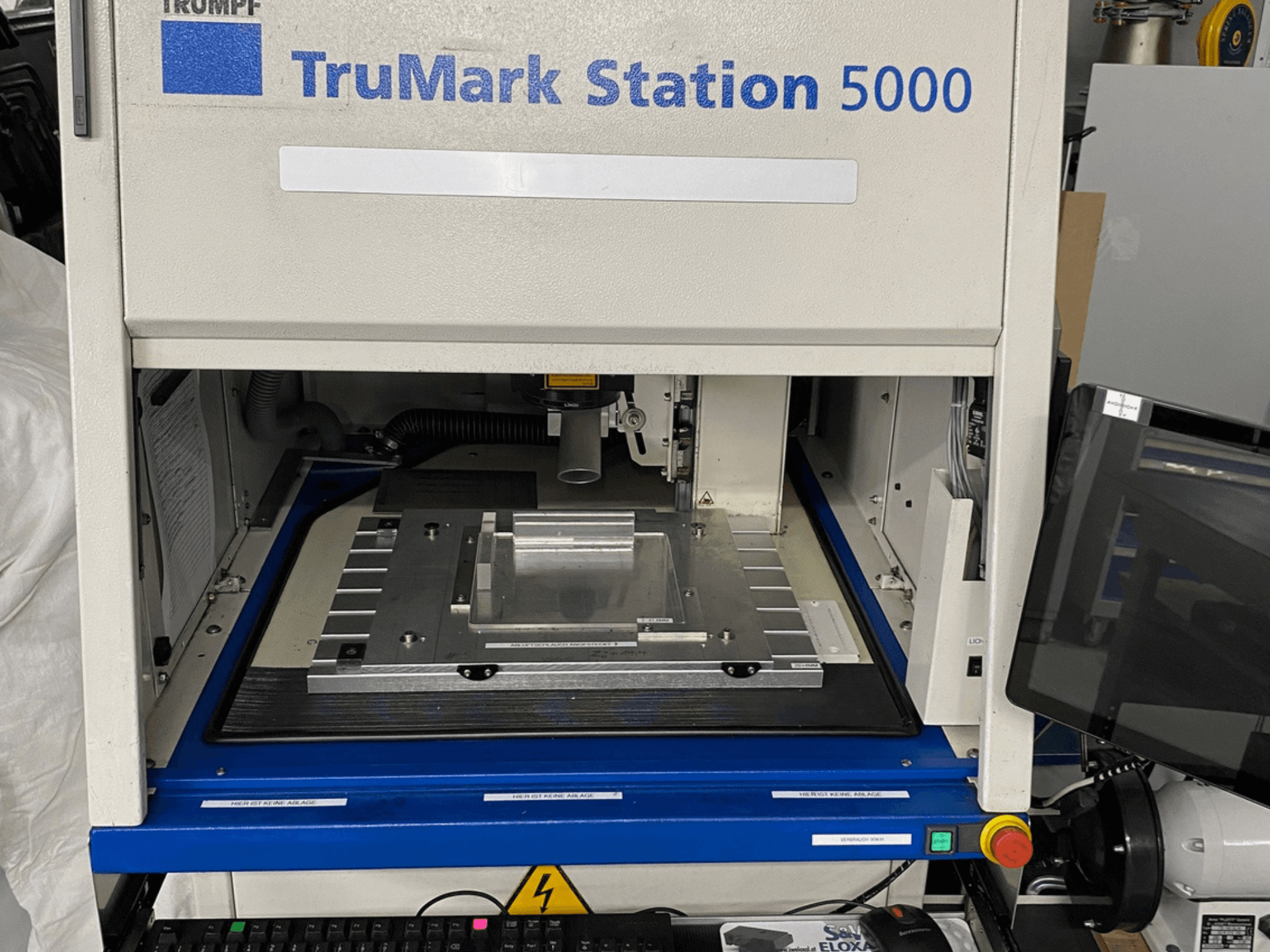 TruMark Station 5000 laser marking machine front view showcasing the work table, controls, and monitoring screen.