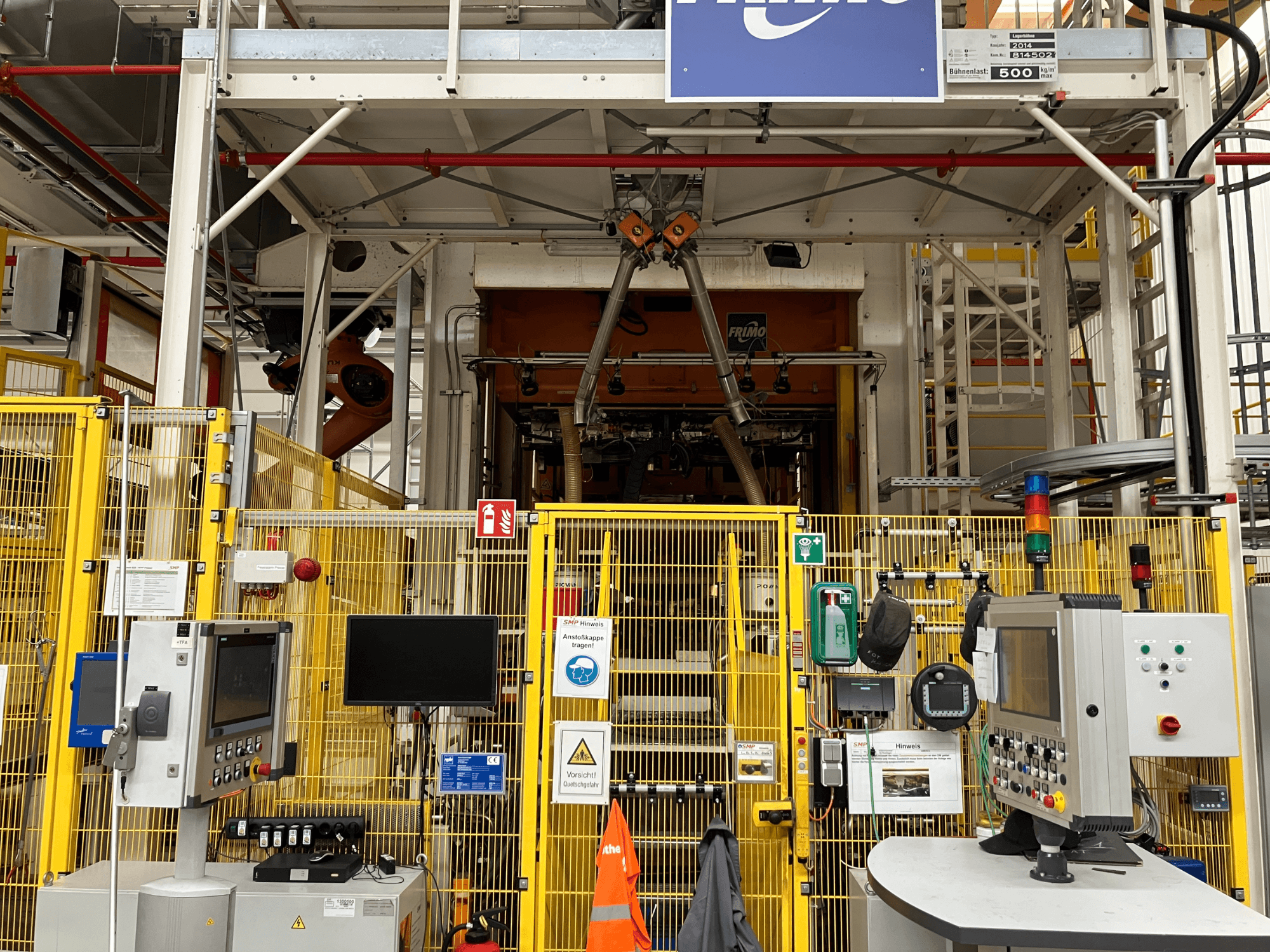 FRIMO NFPP Thermoforming Plant front view, featuring control panels and safety fencing in a well-lit industrial setting.