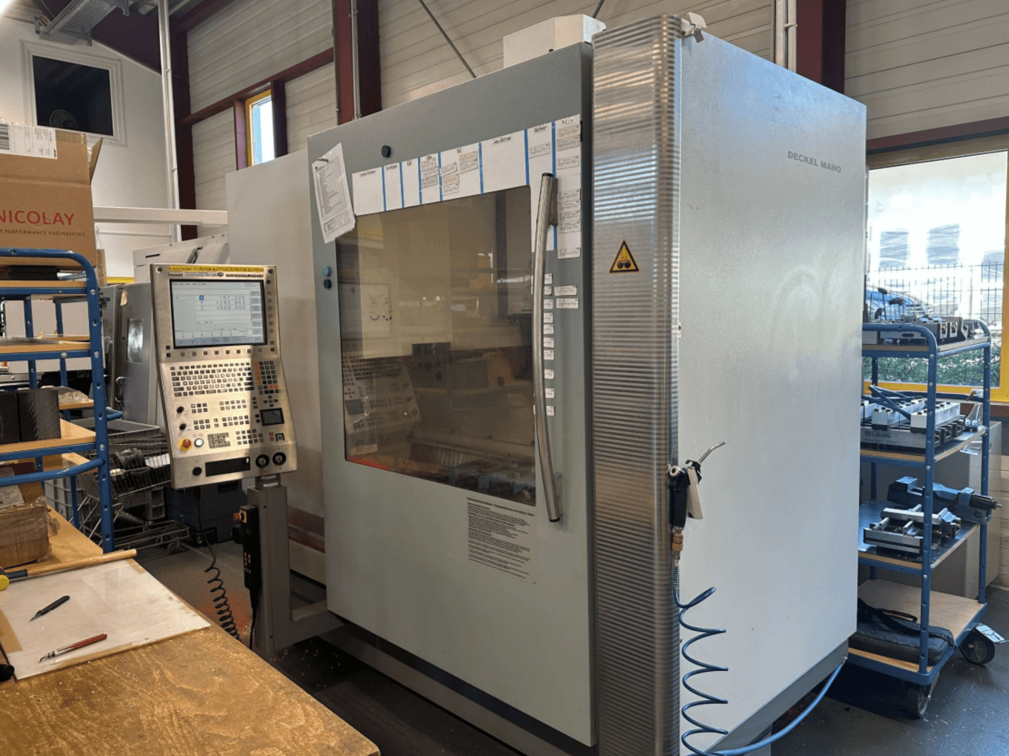 DMG DECKEL MAHO 1035V Vertical Machining Centre, side view showing control panel and machine structure, in a workshop setting.