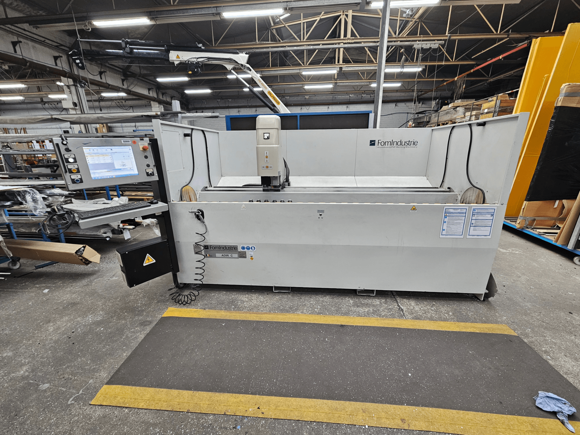 FomIndustrie ADIR C vertical machining centre in a workshop, front view showing control panel and machine details.