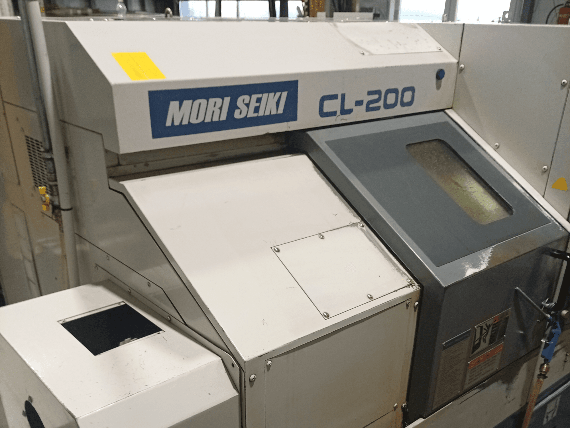 DMG Mori Seiki CL-200B horizontal turning machine, front view showing control panel and coolant window details.