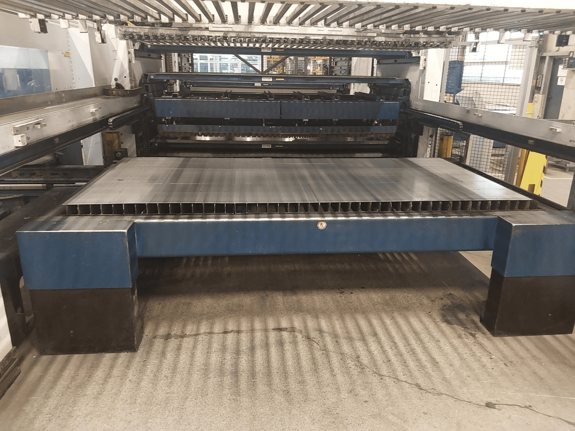 Front view of TRUMPF TruLaser 3030 L20 CO2 laser cutting machine with a large cutting bed and support structure.