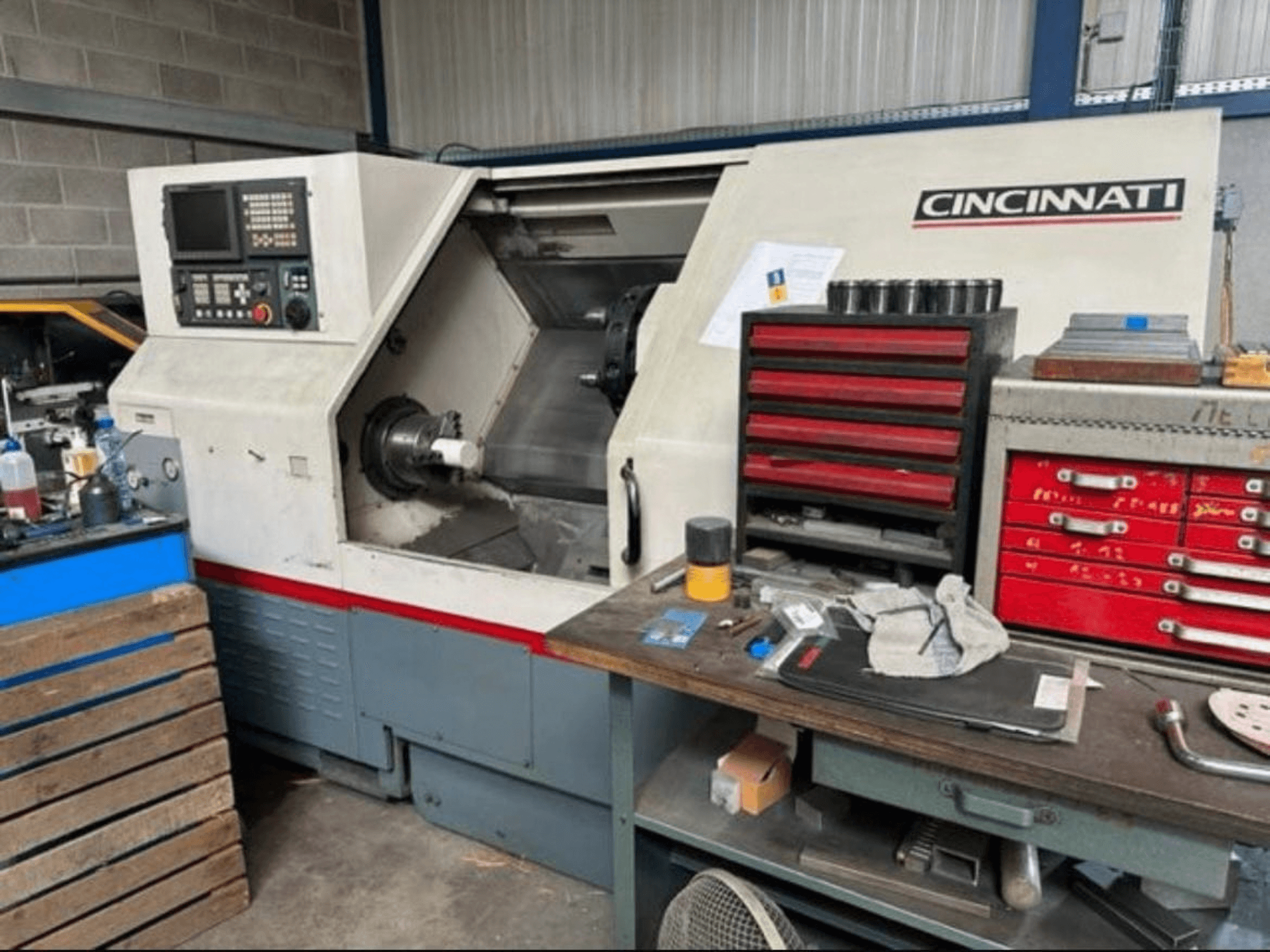 Cincinnati HAWK 200 Horizontal Turning Machine, side view showing control panel, work area, and nearby tool storage.