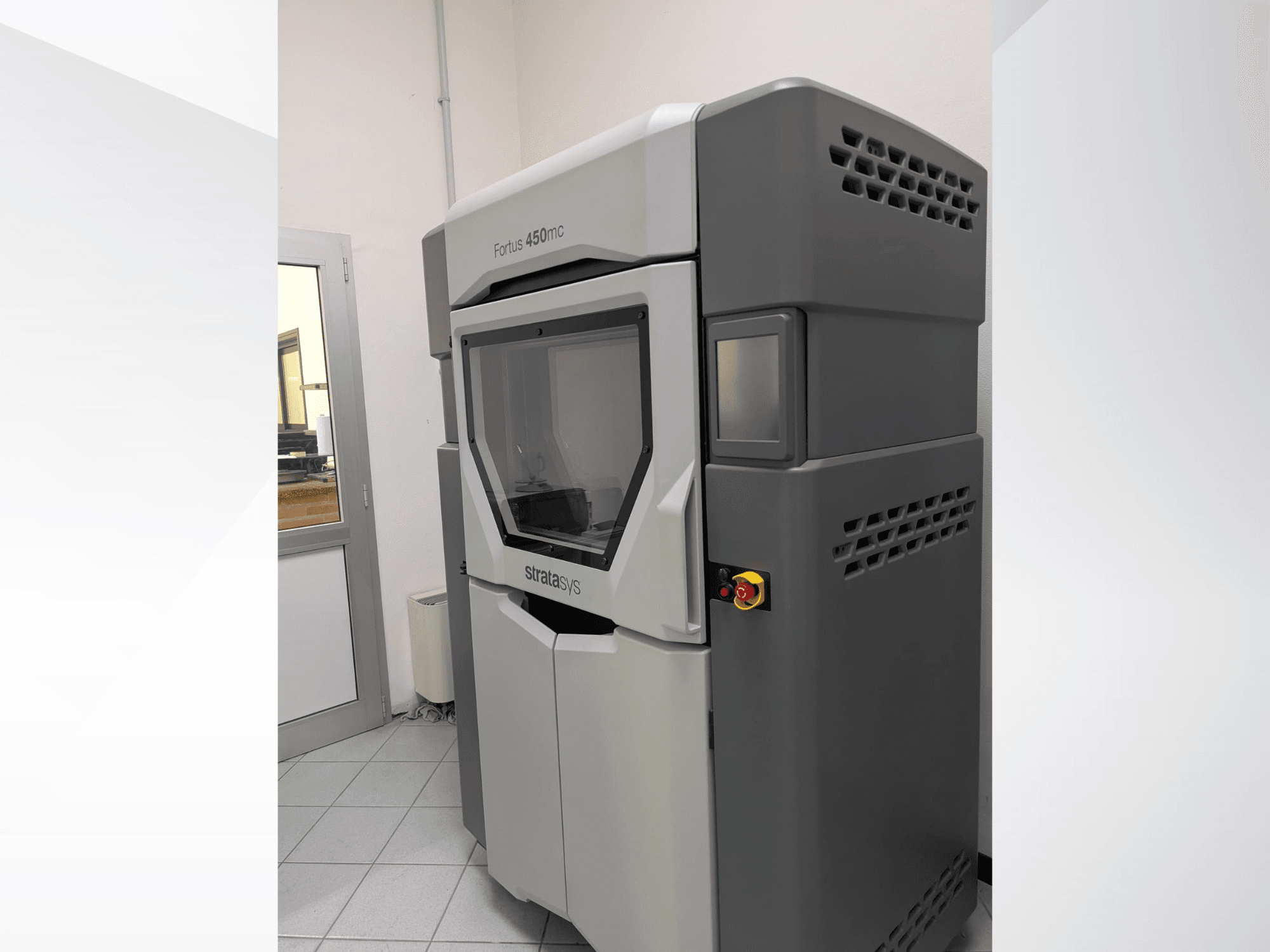 Stratasys FORTUS 450mc plastic 3D printer in a side view, displaying a sleek design and control panel.