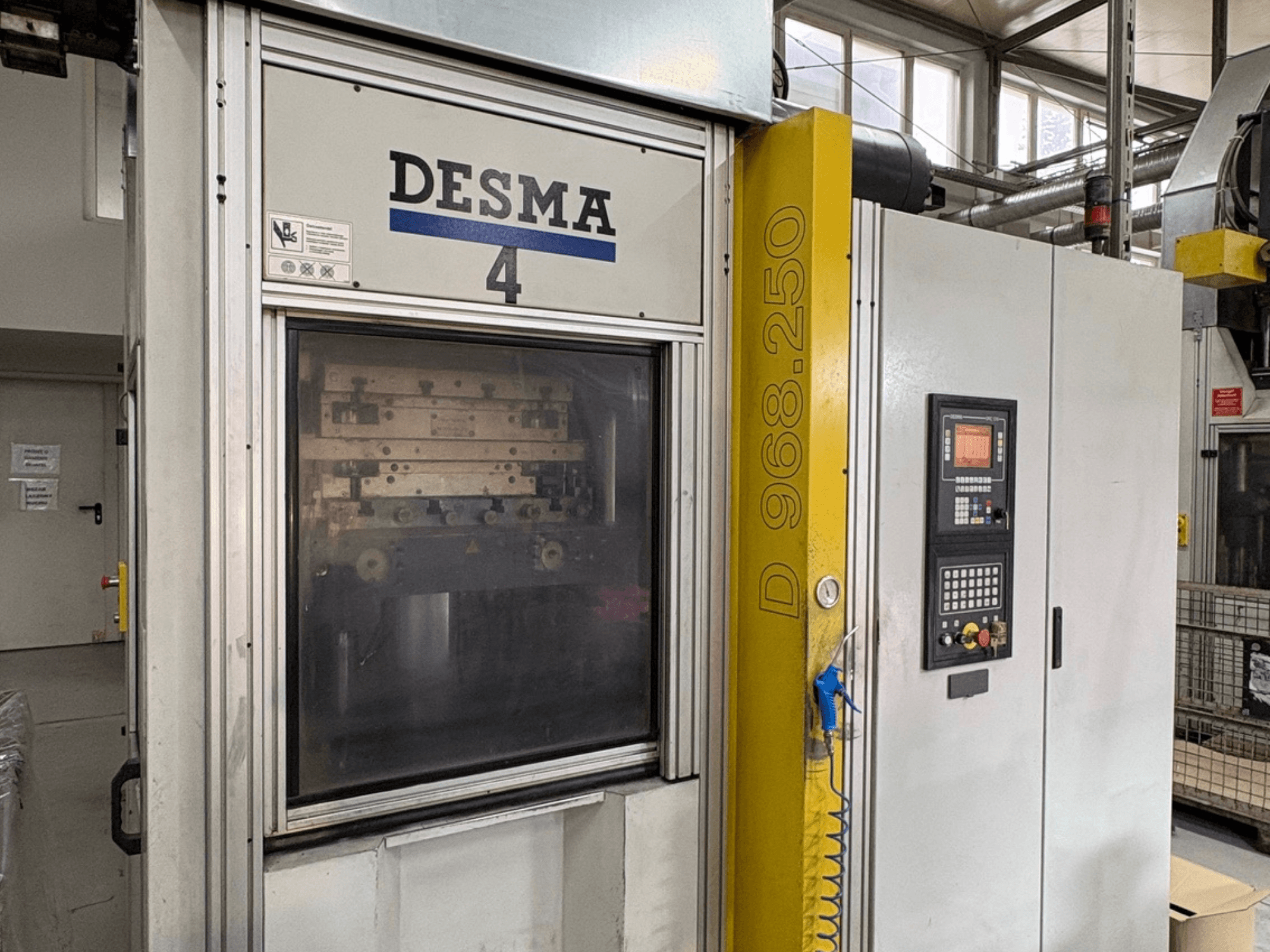 Vertical injection moulding machine Kloeckner Desma 968.250, front view showing control panel and machine details.