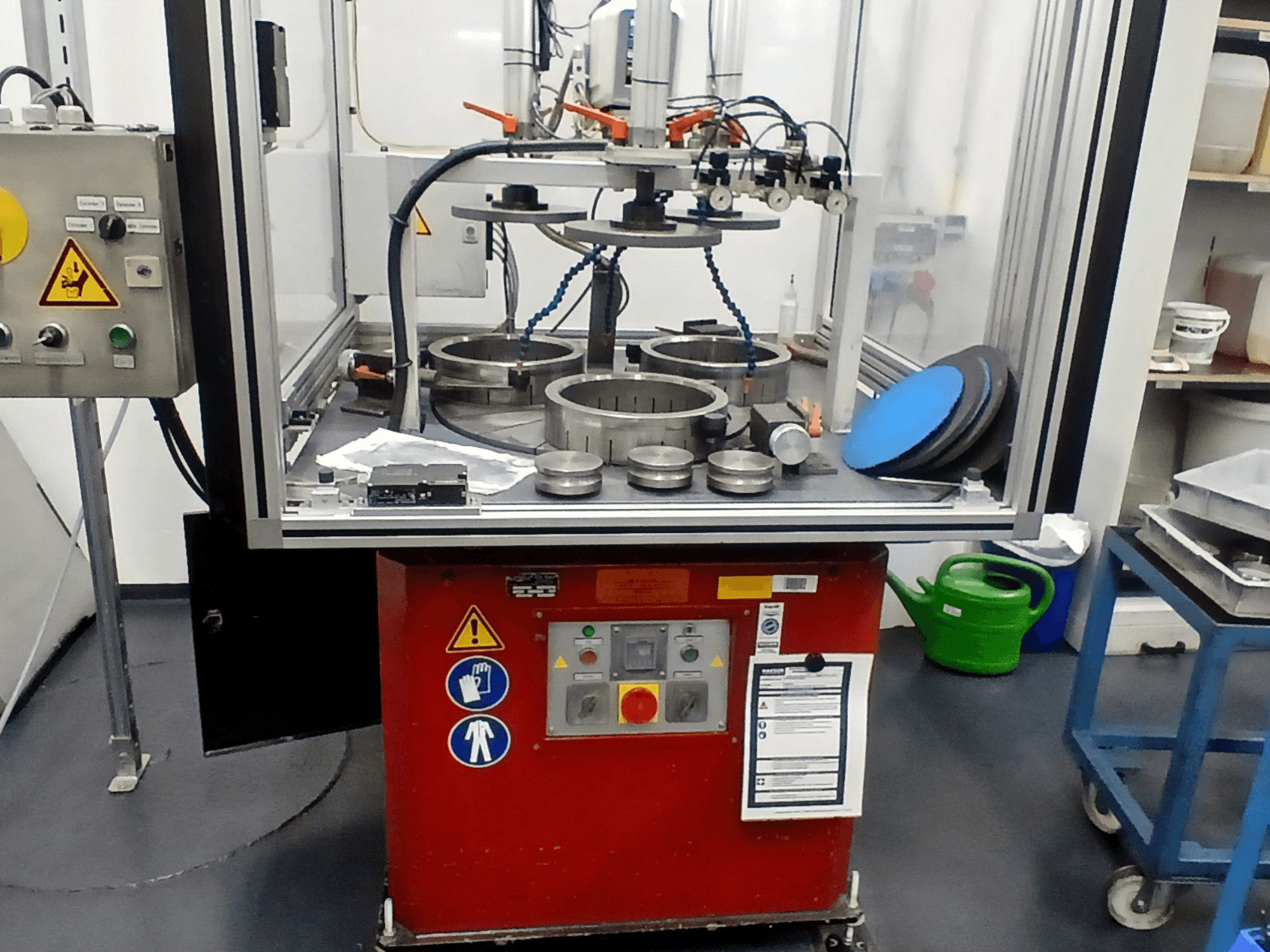 MYLÄP 700 machine tool in front view, showcasing control panel, circular components, and safety features on a red base.