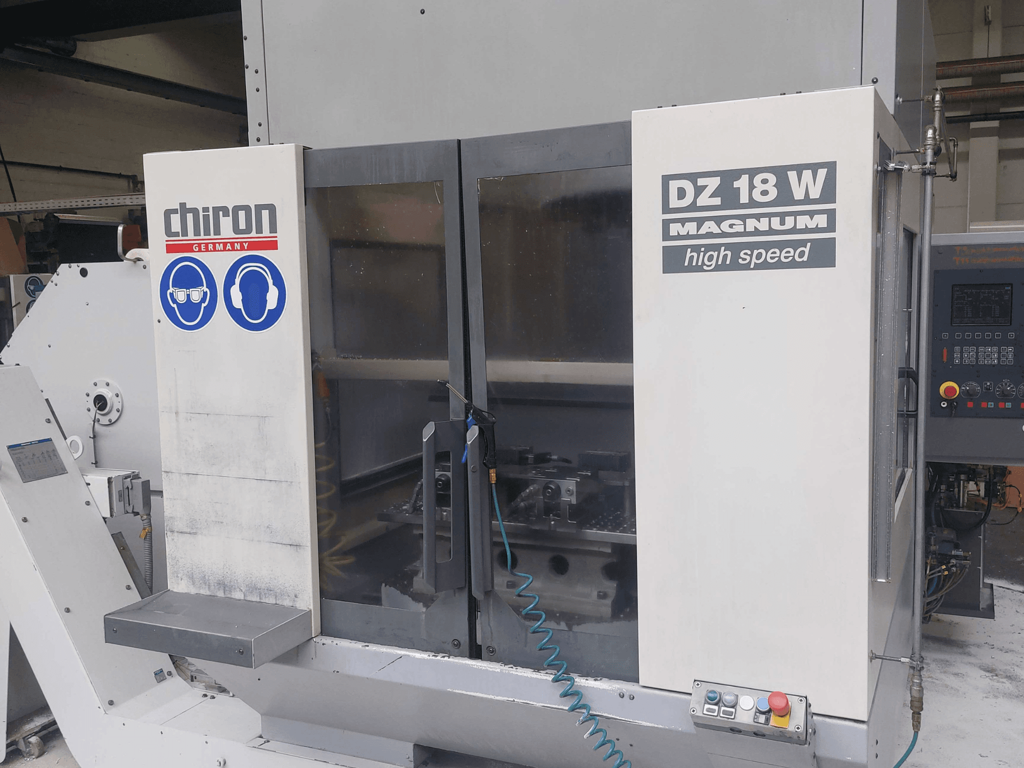 CHIRON DZ 18 W MAGNUM vertical machining centre, front view showing control panel and safety graphics.