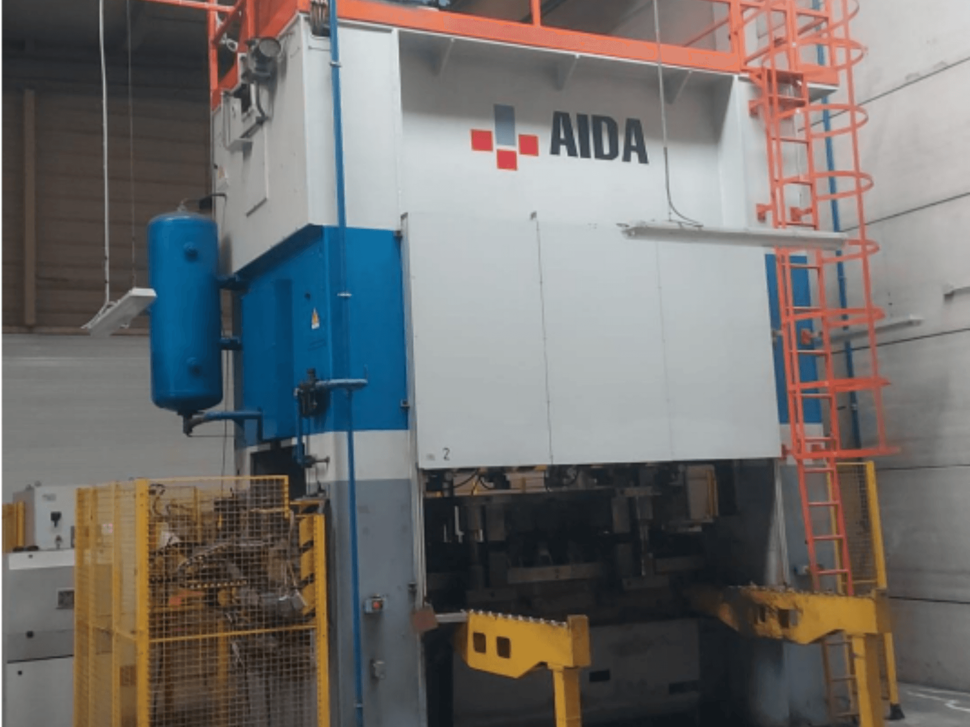 Mechanical stamping press AIDA 315/2MR/LD/TE 3, front view with blue and white body, yellow base, and safety cage.