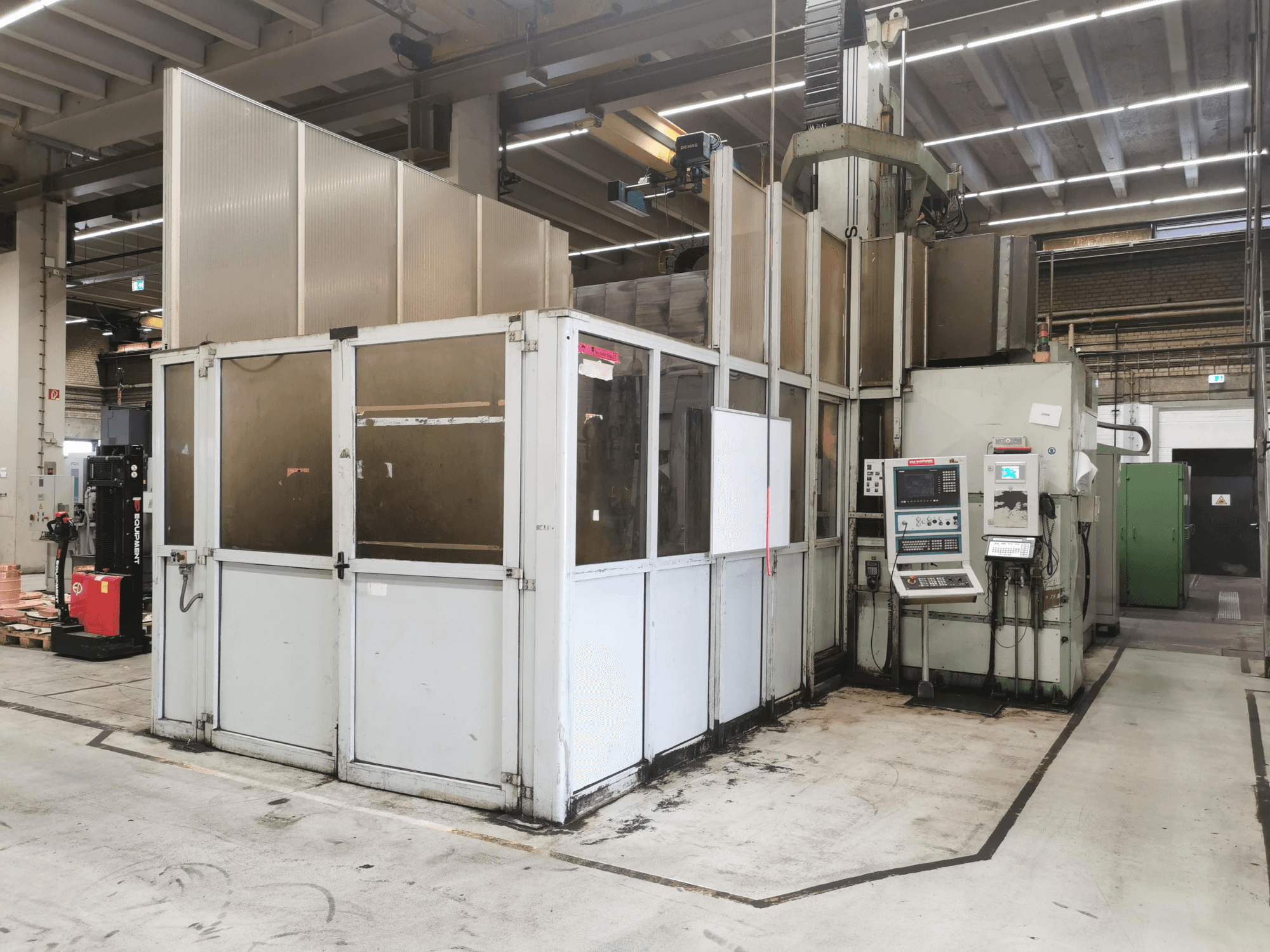 Gantry milling machine JOBS Jomach 241, front view, showcasing machine controls and safety enclosure in a factory setting.