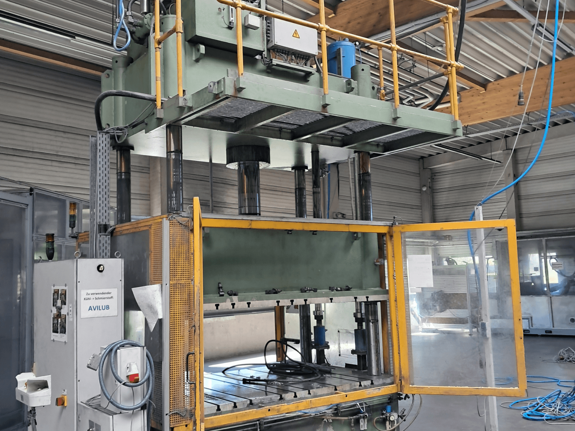 Metal press HS 4 160 by Other, front view, with open door, showing hydraulic cylinders and control panel.