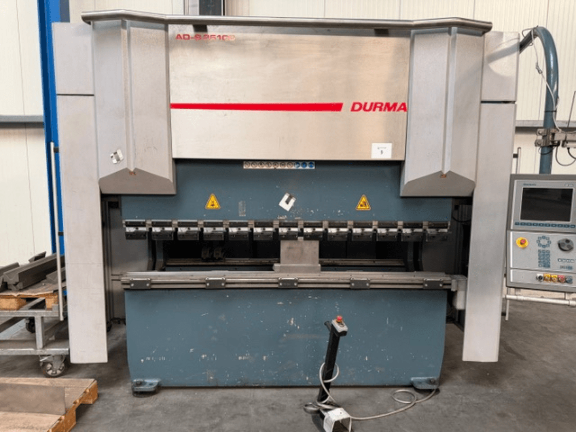 Durma ADS 25100 press brake front view with control panel, showcasing bending tools and safety labels.