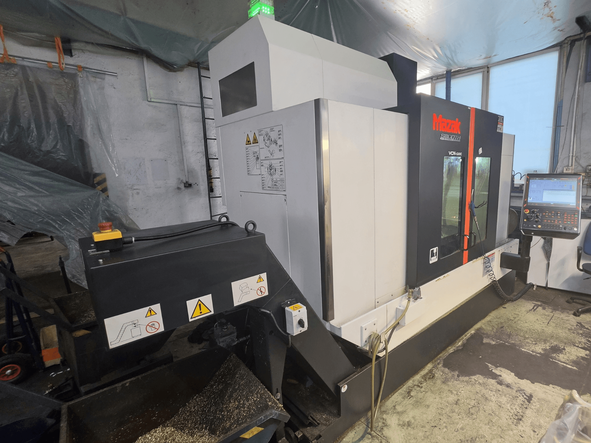 Mazak VCN-530C Vertical Machining Centre front view, showing control panel, tool chain, and operational indicators.