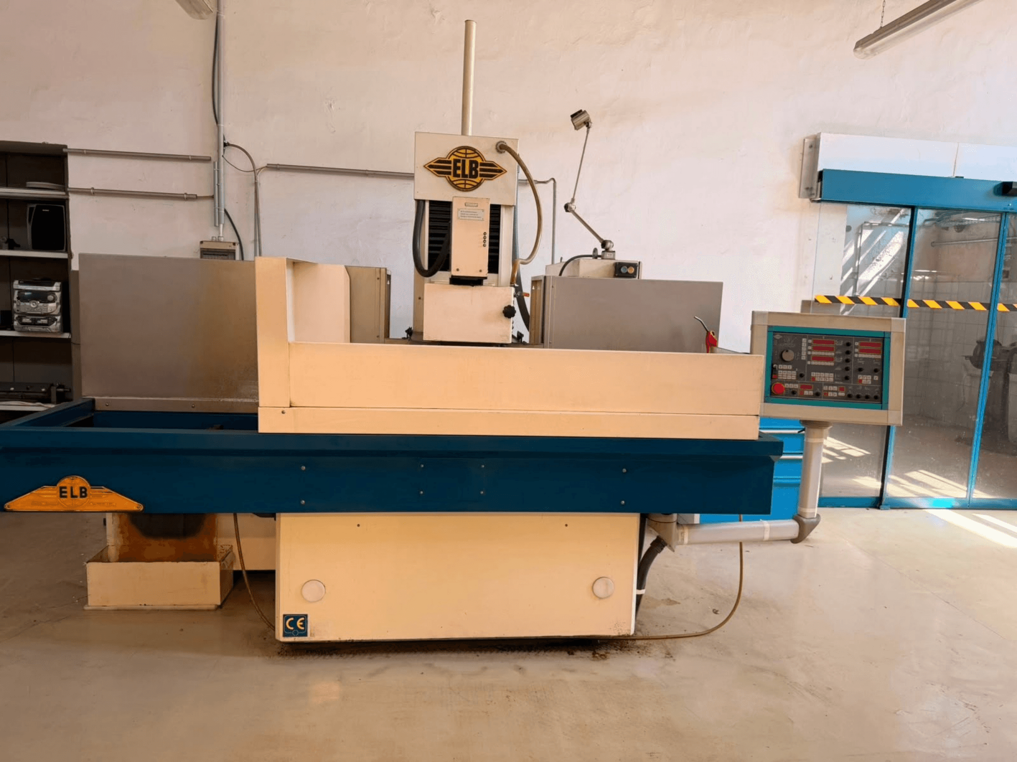 ELB Schliff Perfket 6 SPS-NK surface grinding machine, front view with control panel and blue base, in a workshop setting.