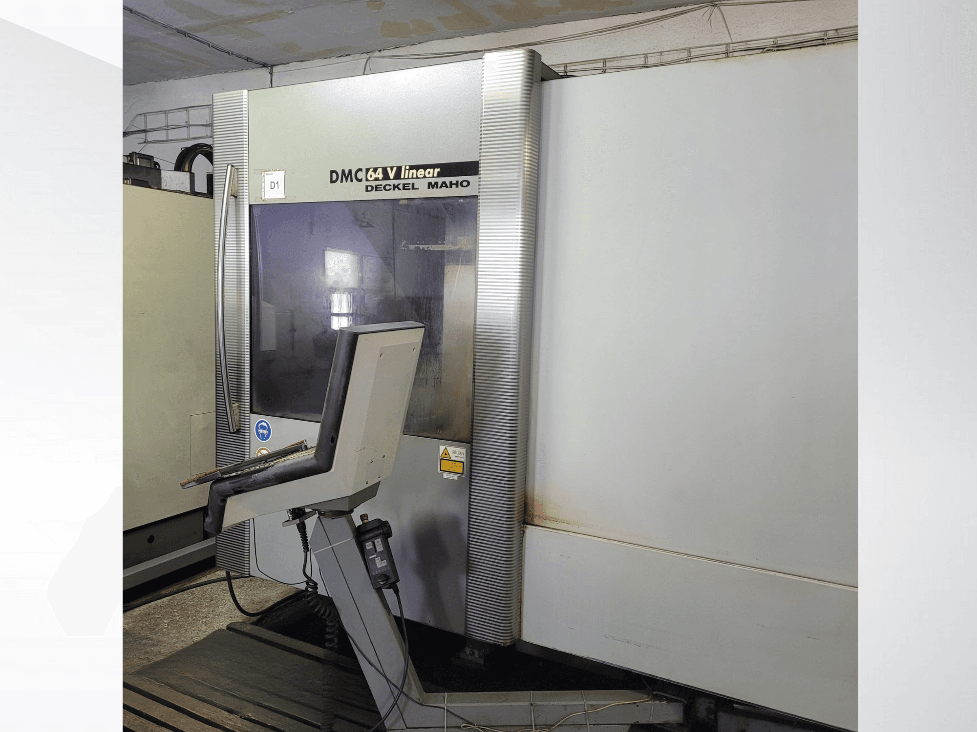 Alt text: DMC 64 V linear milling machine by Deckel Maho, front view showing control panel and metallic exterior.