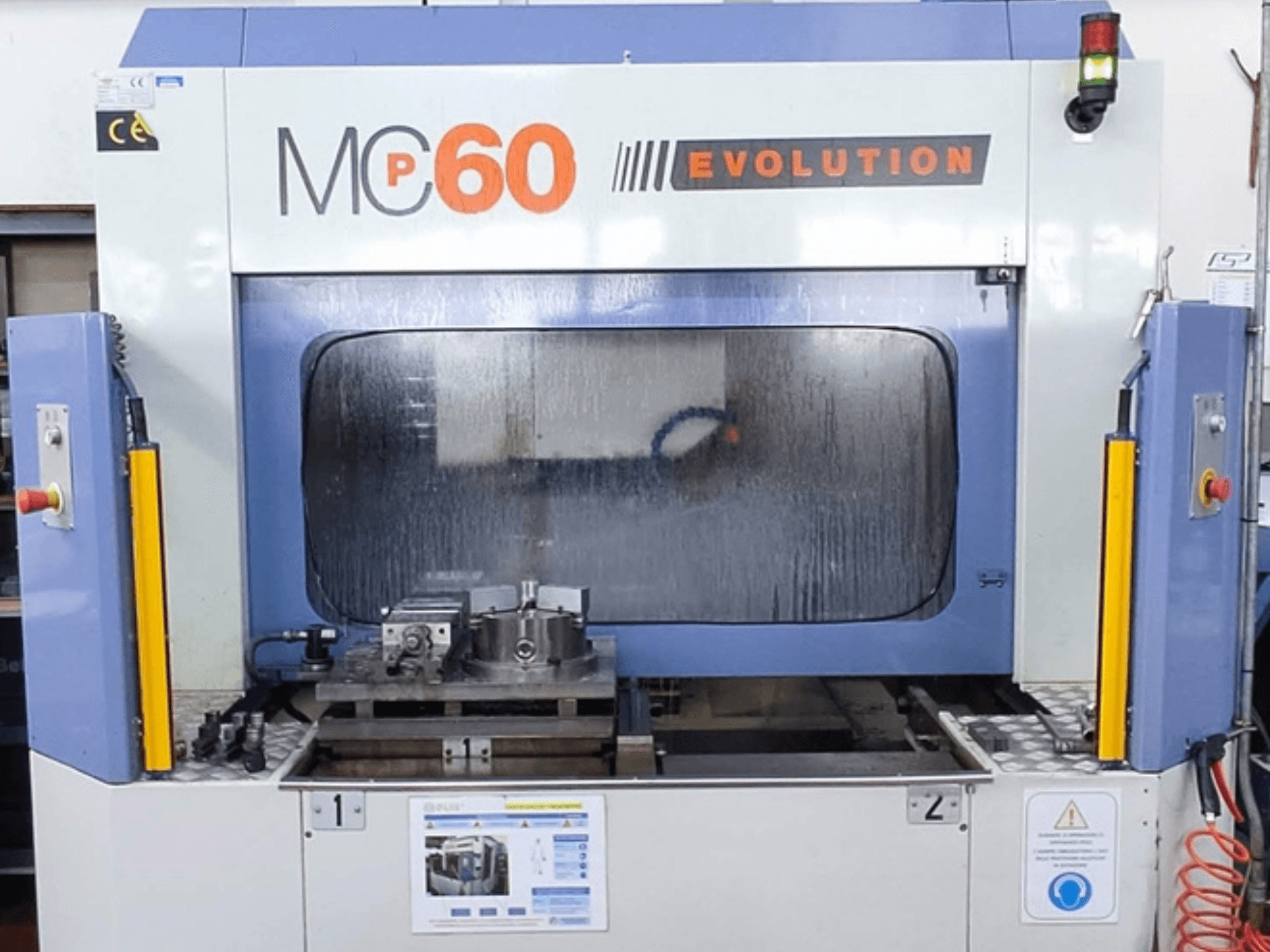 Vertical machining center FAMUP MCP 60 E front view, featuring a control panel and tooling in the workspace.
