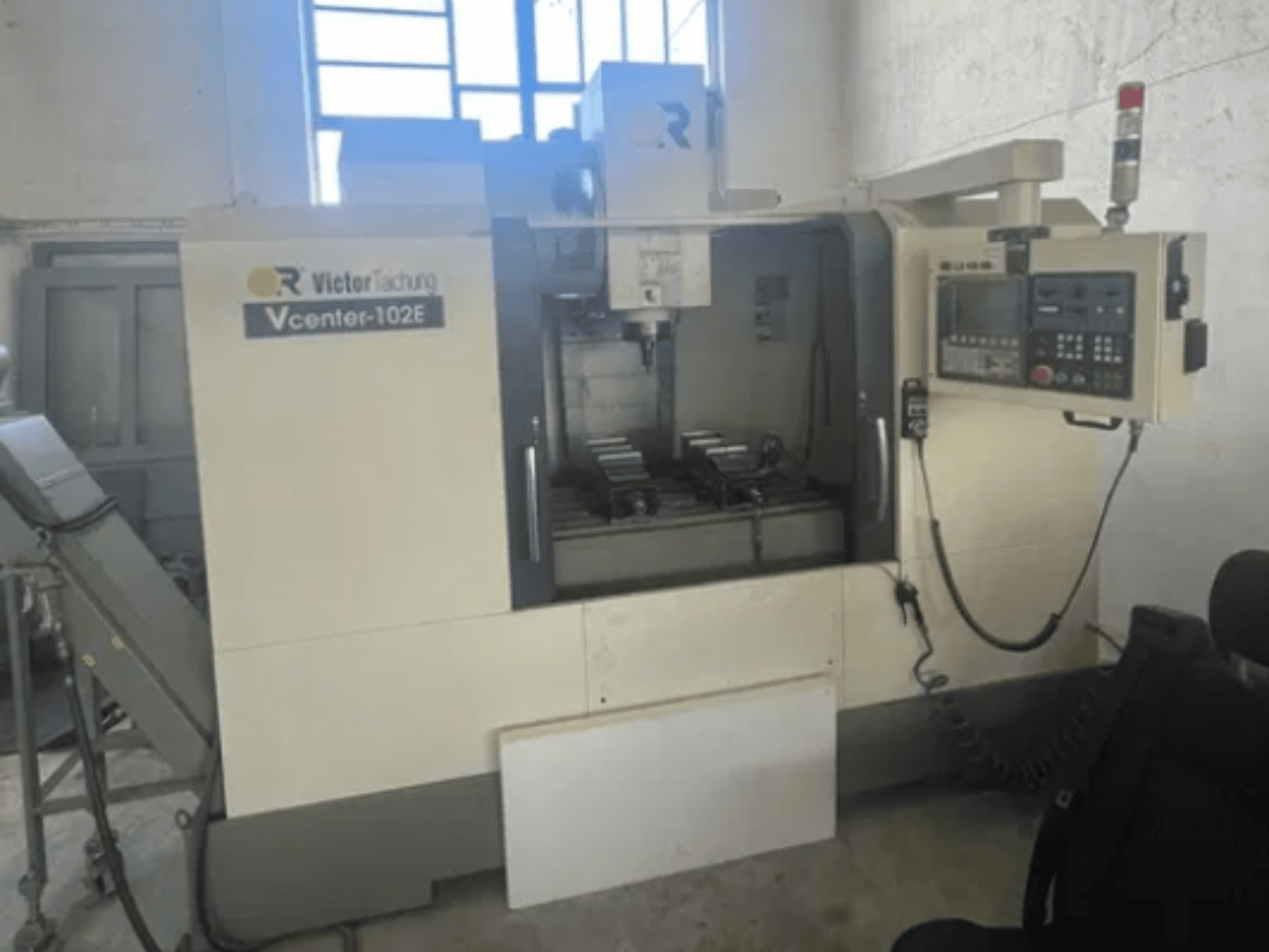 Vertical Machining Centre by VICTOR TAICHUNG, model Vcenter-102E, front view showcasing control panel and machining area.