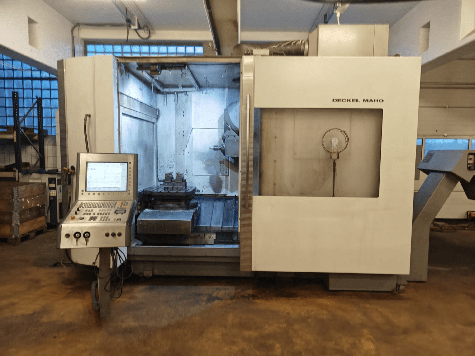 DECKEL MAHO DMC 60U Universal Machining Centre, front view, featuring control panel and machining area with workpiece setup.