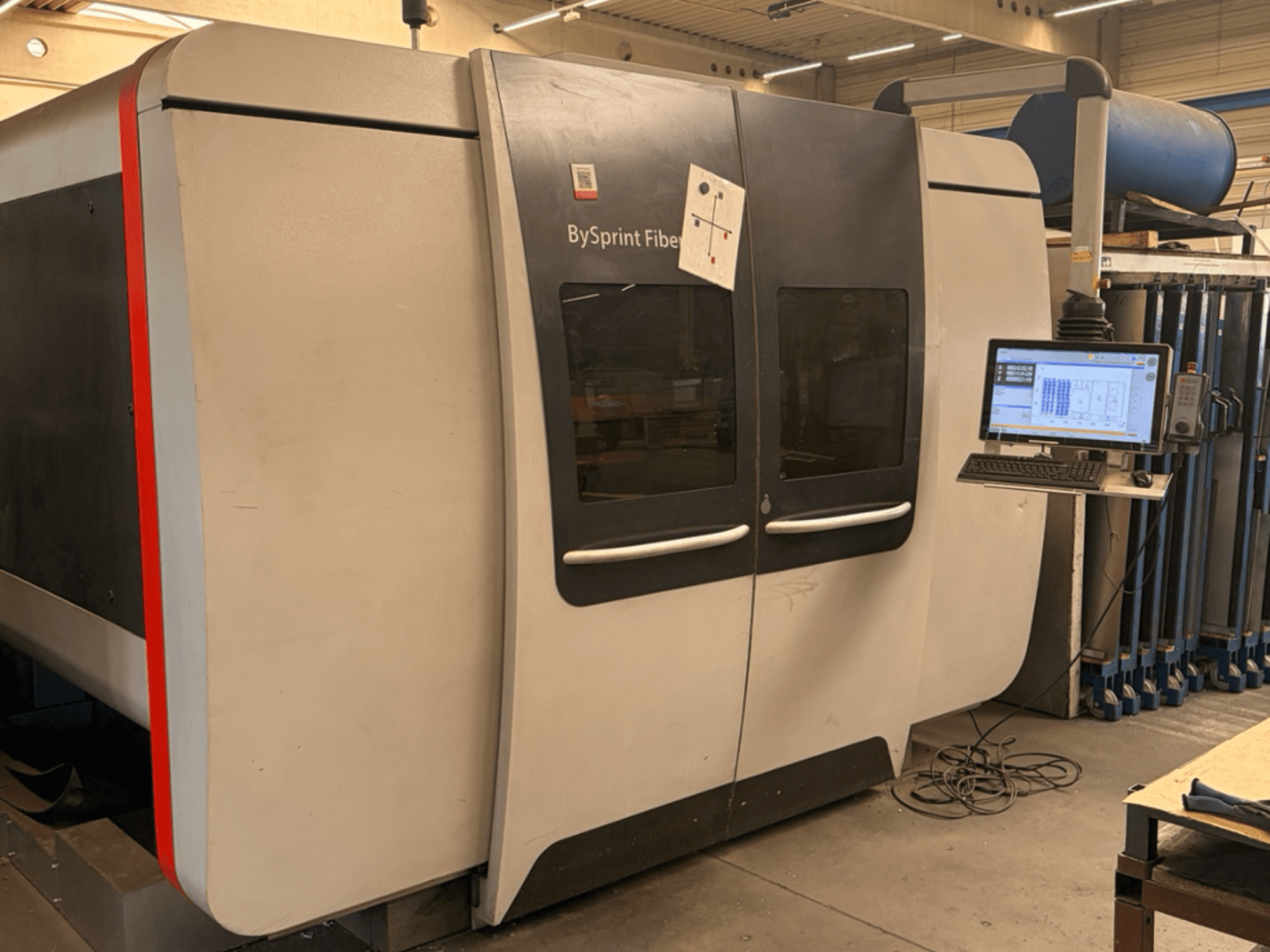 Bystronic BySprint Fiber 3015, front view of fiber laser cutting machine with touchscreen control panel and industrial setting.