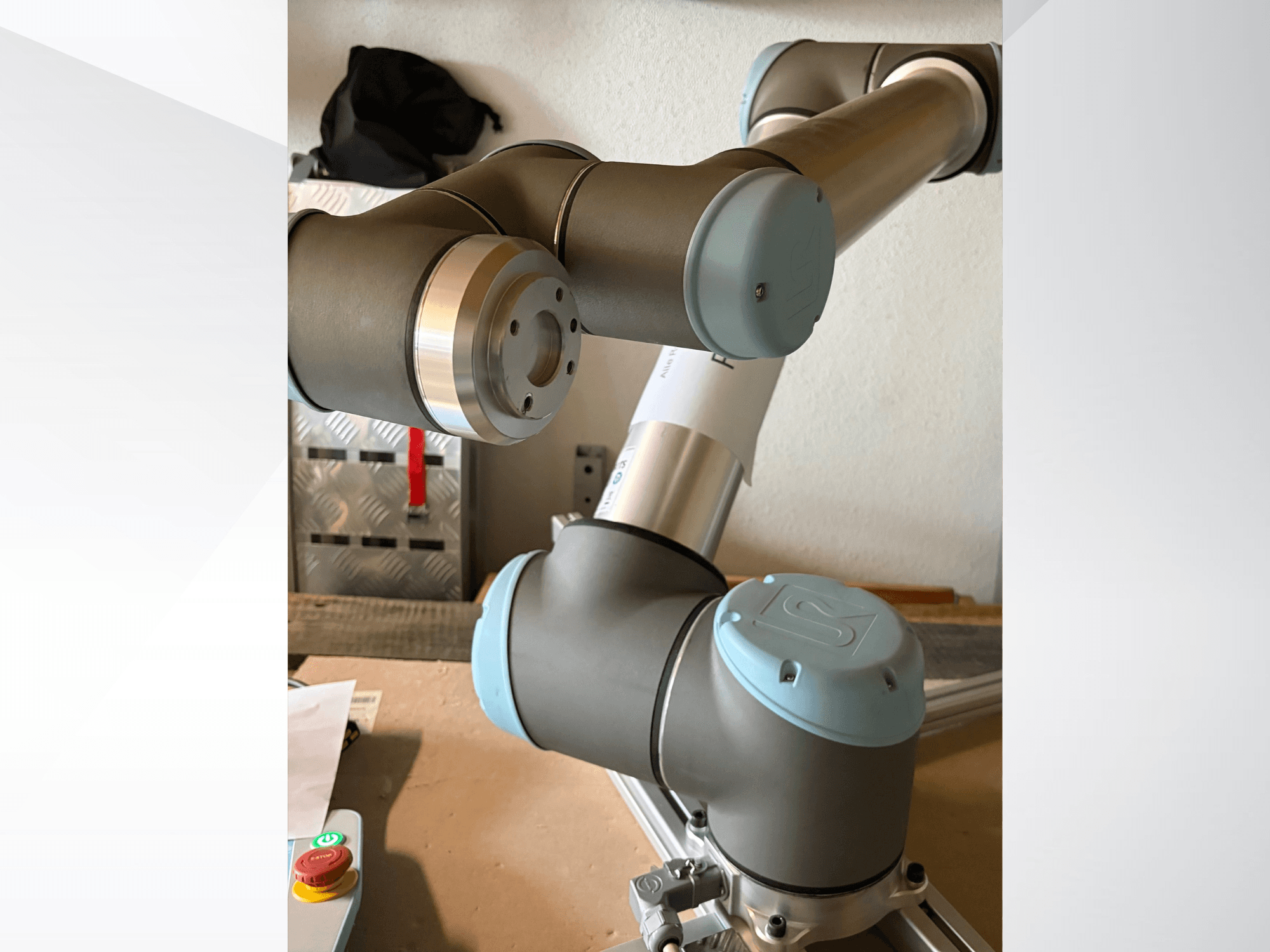 Close-up side view of a Universal Robots UR10 robotic arm, highlighting joints and gray-blue design elements.