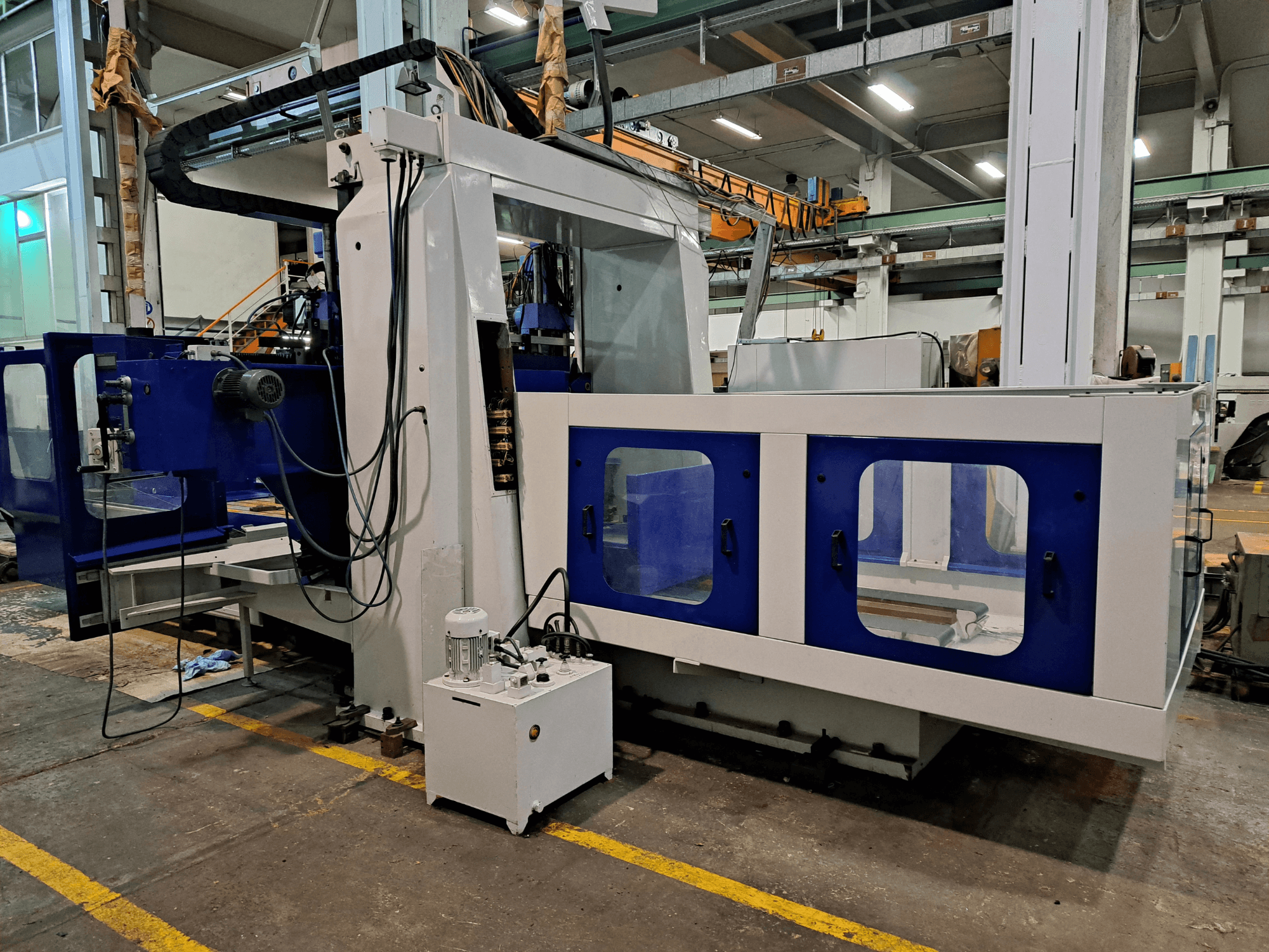 DYE RHE-3000 Bed Type Milling Machine in a workshop, front view showing its large blue and white frame and control panel.