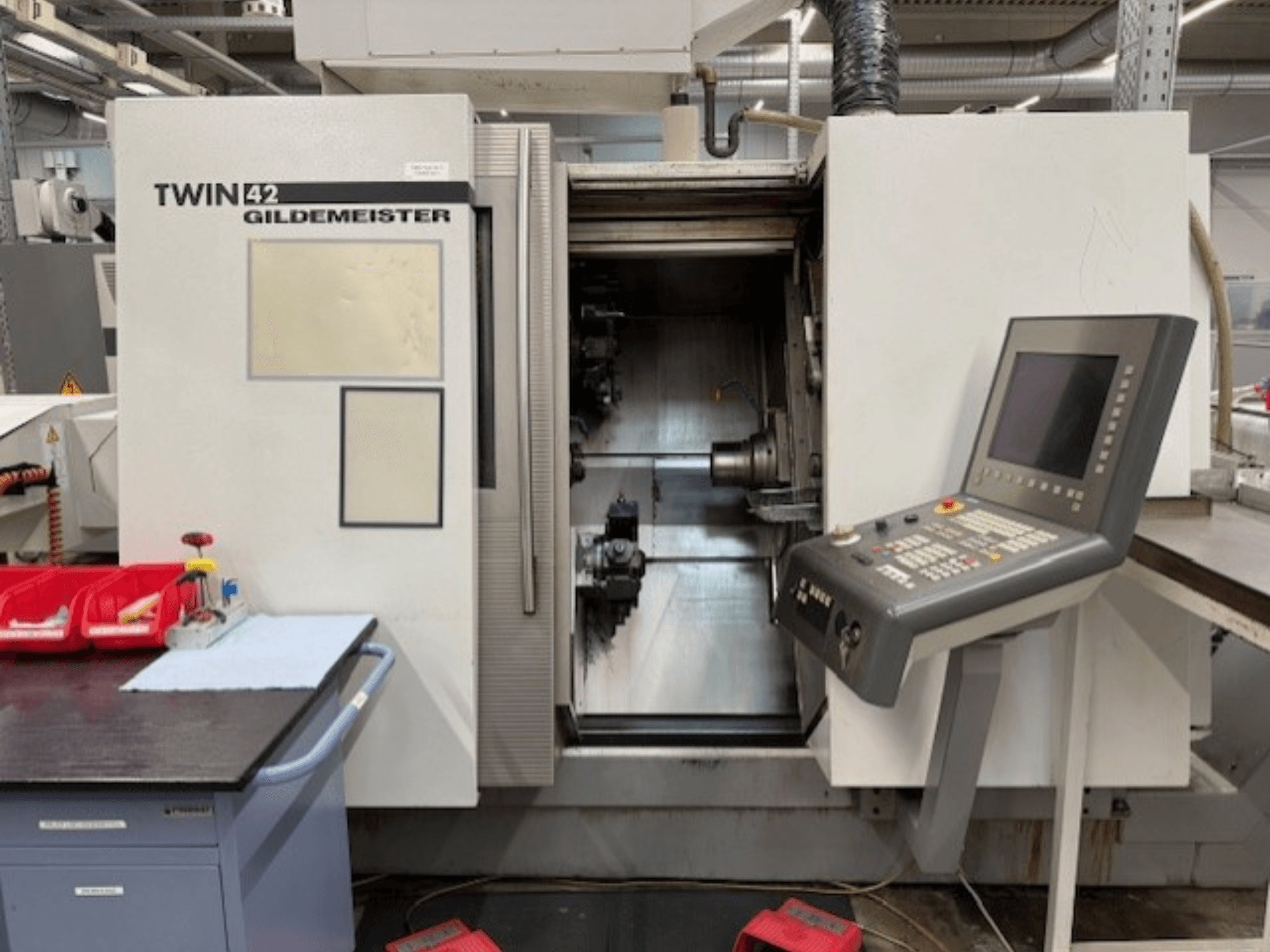 Gildemeister TWIN 42 horizontal turning machine; front view showing control panel and open spindle chamber.