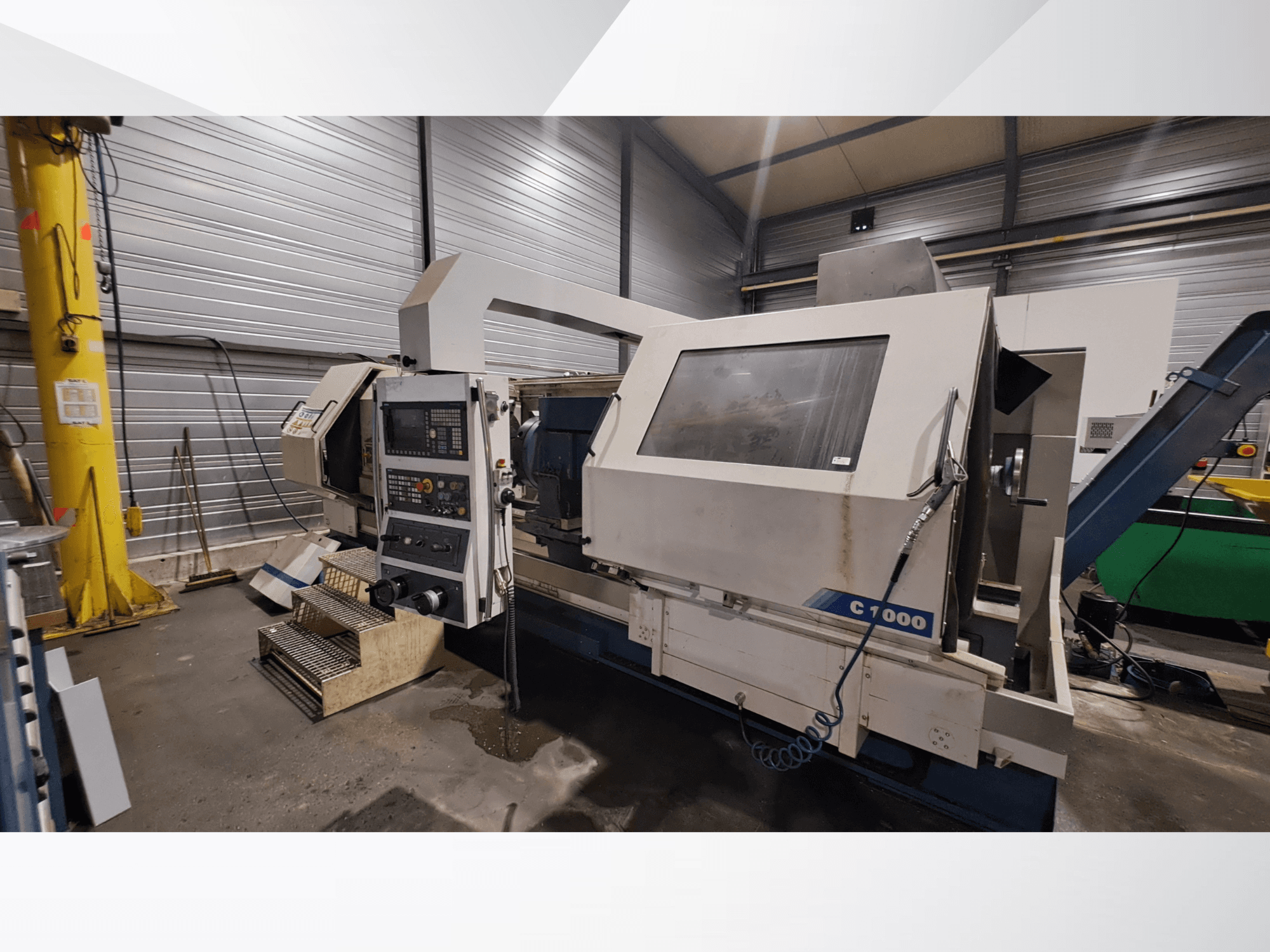 Romi C1000 horizontal turning machine in a workshop, showcasing control panel, spindle, and operational components from a side view.