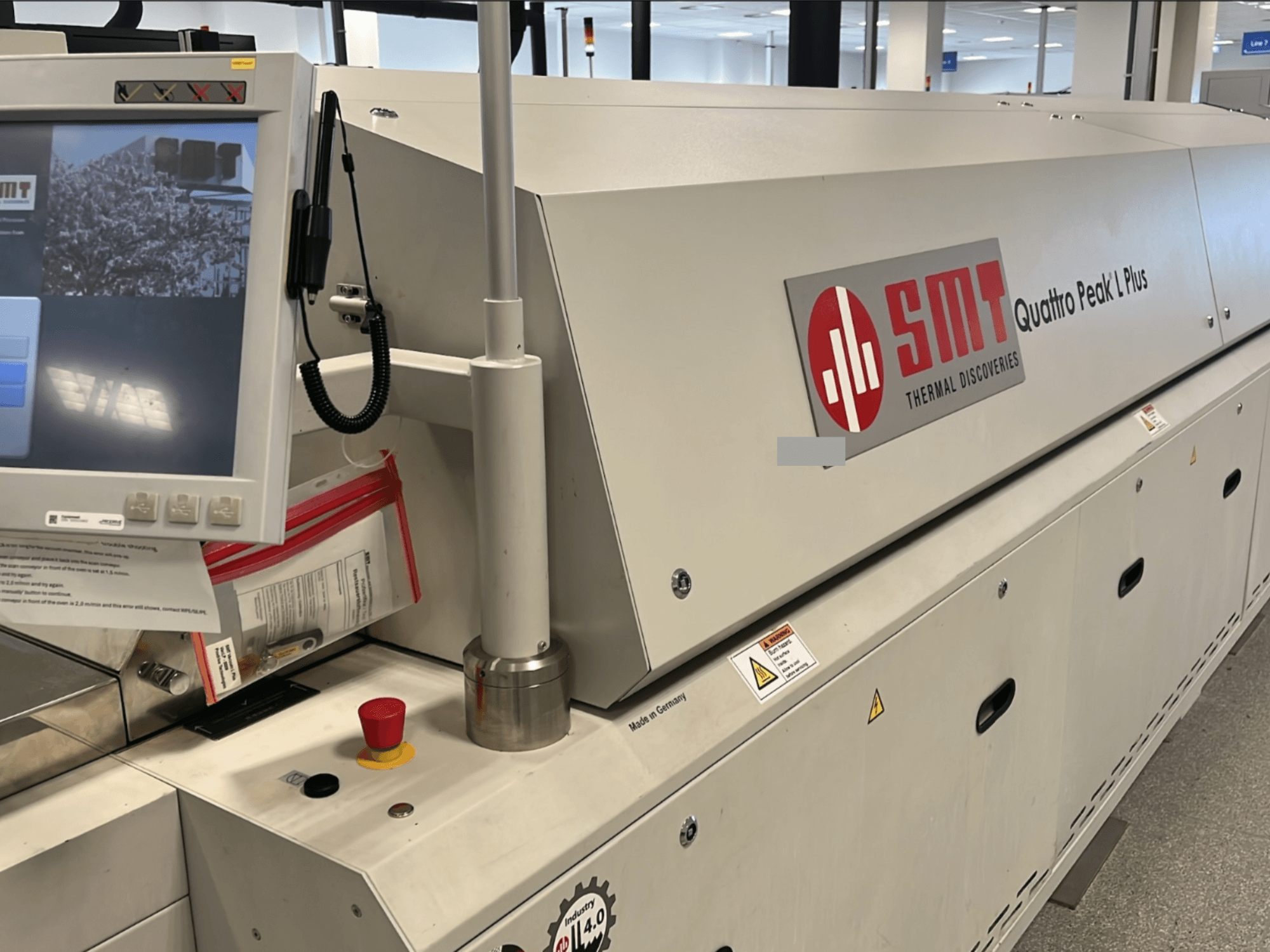 SMT Quattro Peak L Plus machine tool, front view, featuring control panel, safety buttons, and branding clearly visible.